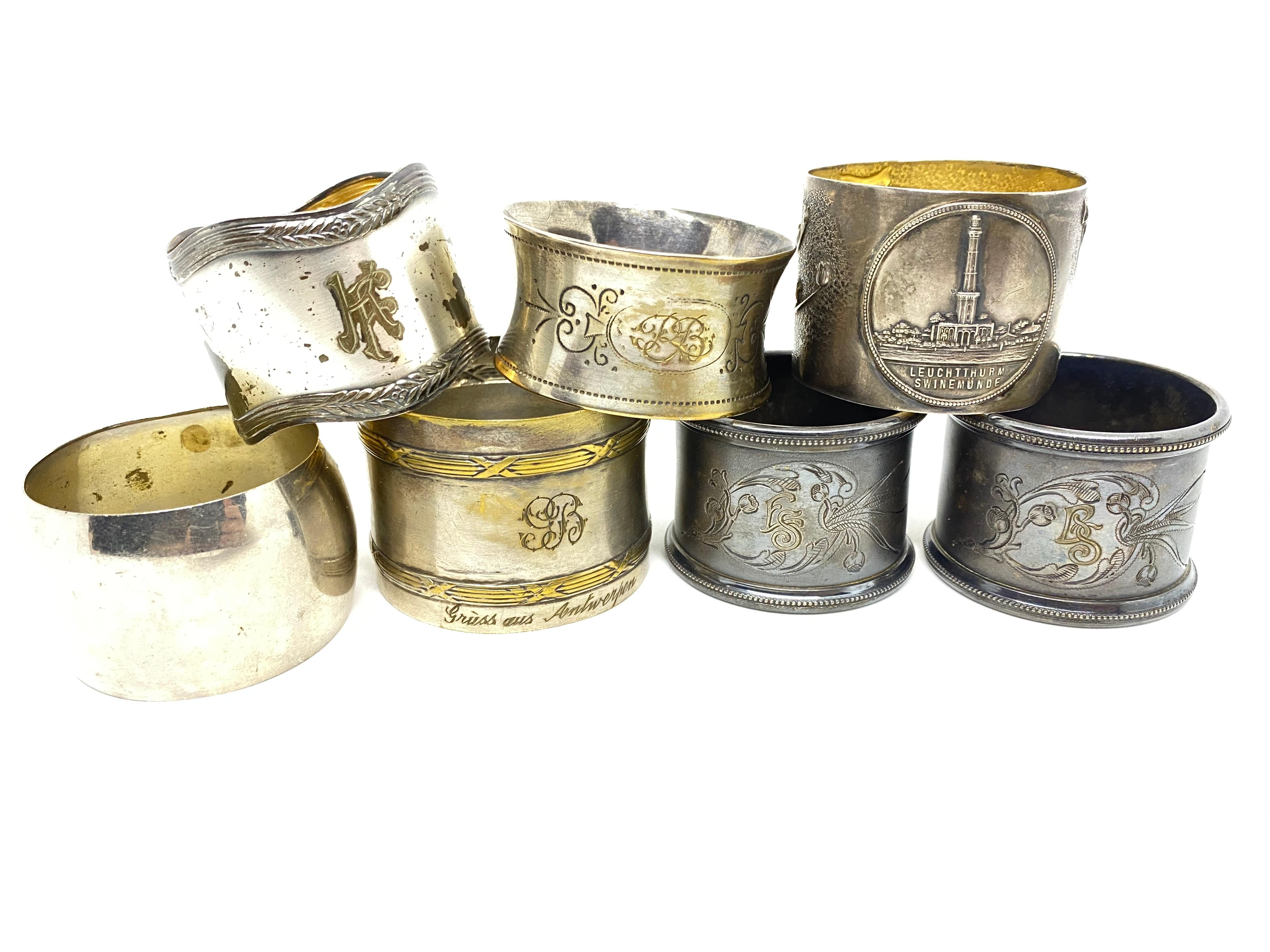 A mixed set of seven silver plated napkin rings, circa 1910-1930s, various makers. A nice selection of barrel, rectangular, paneled and round rings, one Art Nouveau, one with Lighthouse, all engraved with letters (monogram), ranging in size from 1.5