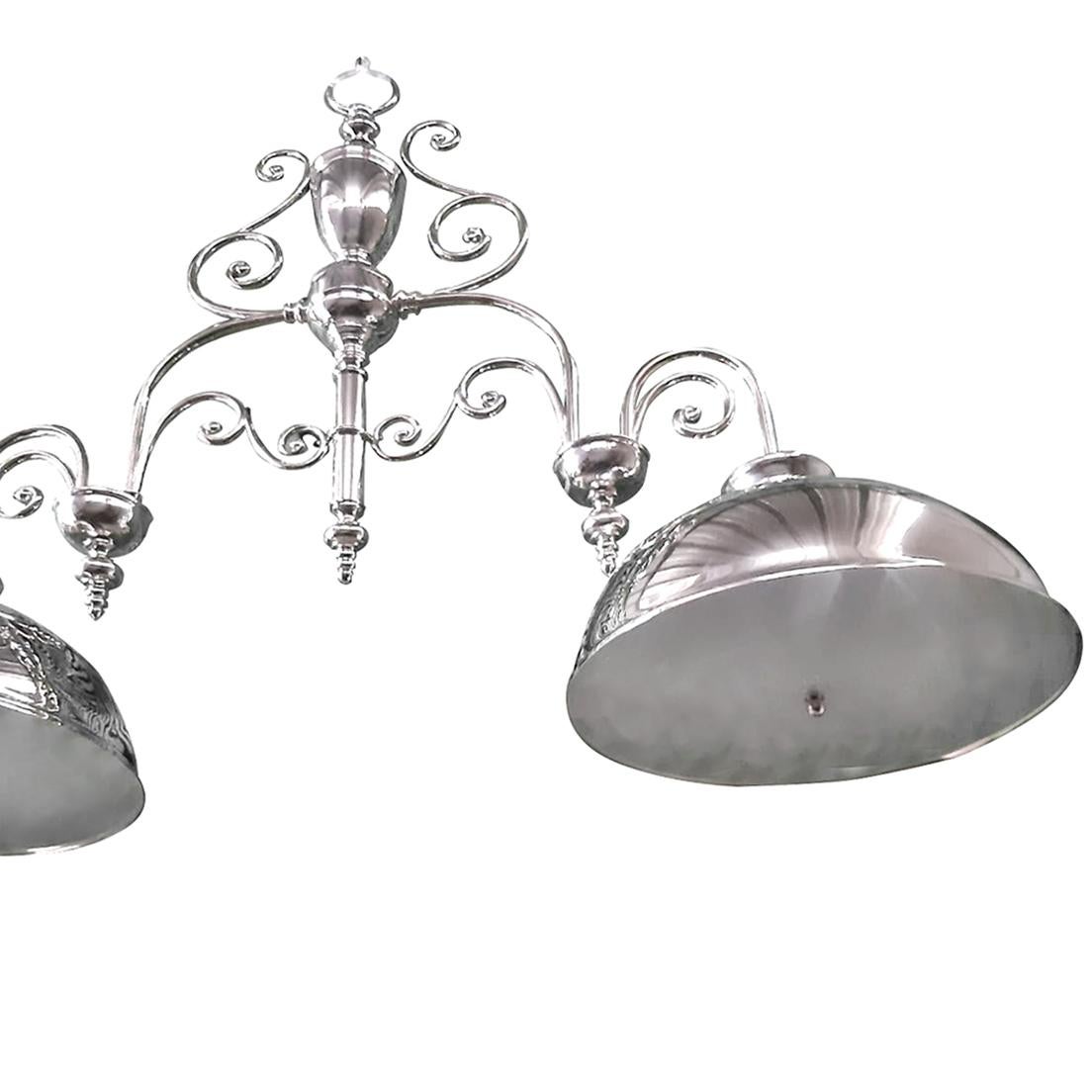 A circa 1950's English silver-plated light fixture with two downward shades; four interior lights in each shade.

Measurements:
Length: 56