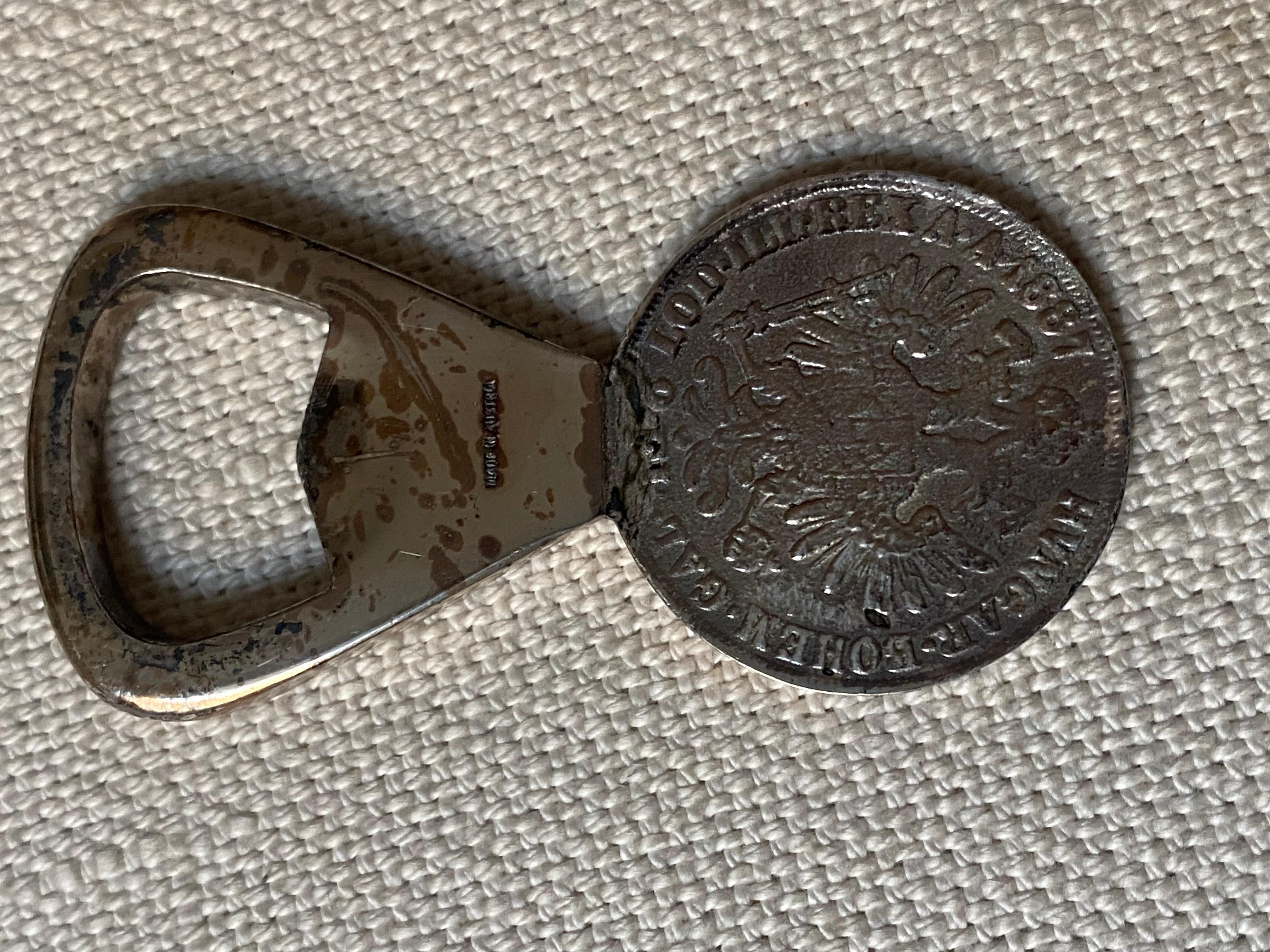 Silver plated brass coin bottle opener, incorporating a 2 florin coin, by Carl Auböck, circa 1950.
The front shows a Facsimile coin, dated 1881, with a portrait of Franz Joseph I facing right.
With an embossing on the bottle opener: 