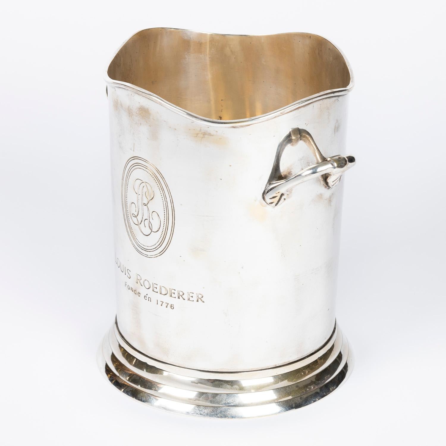 Ein versilberter Champagner-Eiskübel für Louis Roederer von James Deakin & Sons aus Sheffield.

Gezeichnet: LOUIS ROEDERER Fonde én 1776.

Mit der Marke von James Deakin & Sons of Sheffield auf der Unterseite des Sockels.

Die Flasche ist