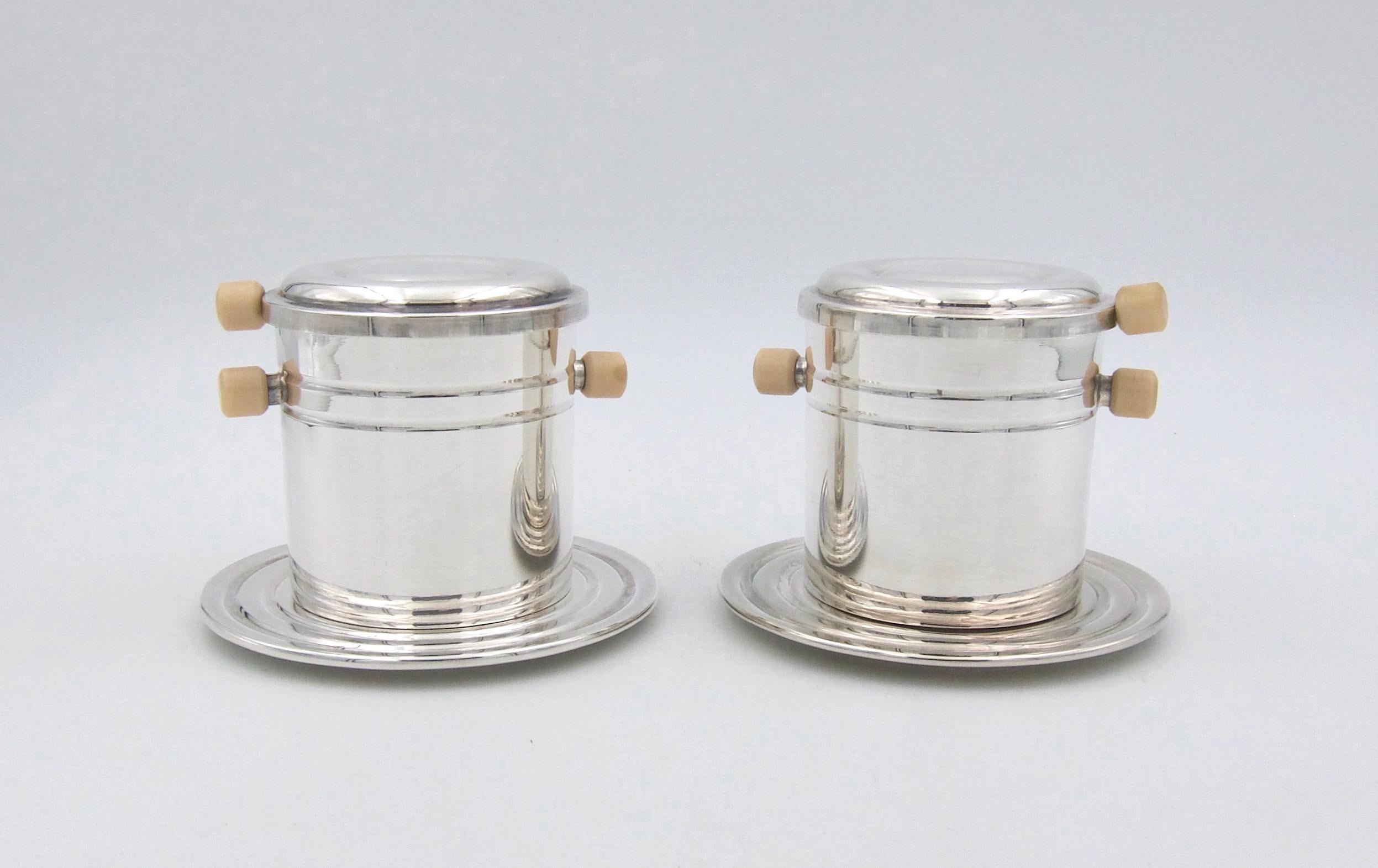 A pair of Christofle of Paris Art Deco coffee strainers from the original line of Gallia metal silver plated luxury goods. The coffee strainers rest atop a cup or mug and serve as an individual French press for a single cup of coffee. Made in France