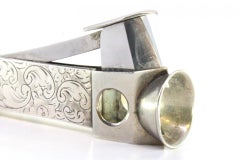 Silver-plated cigar cutter with engraved wreaths and steel interior