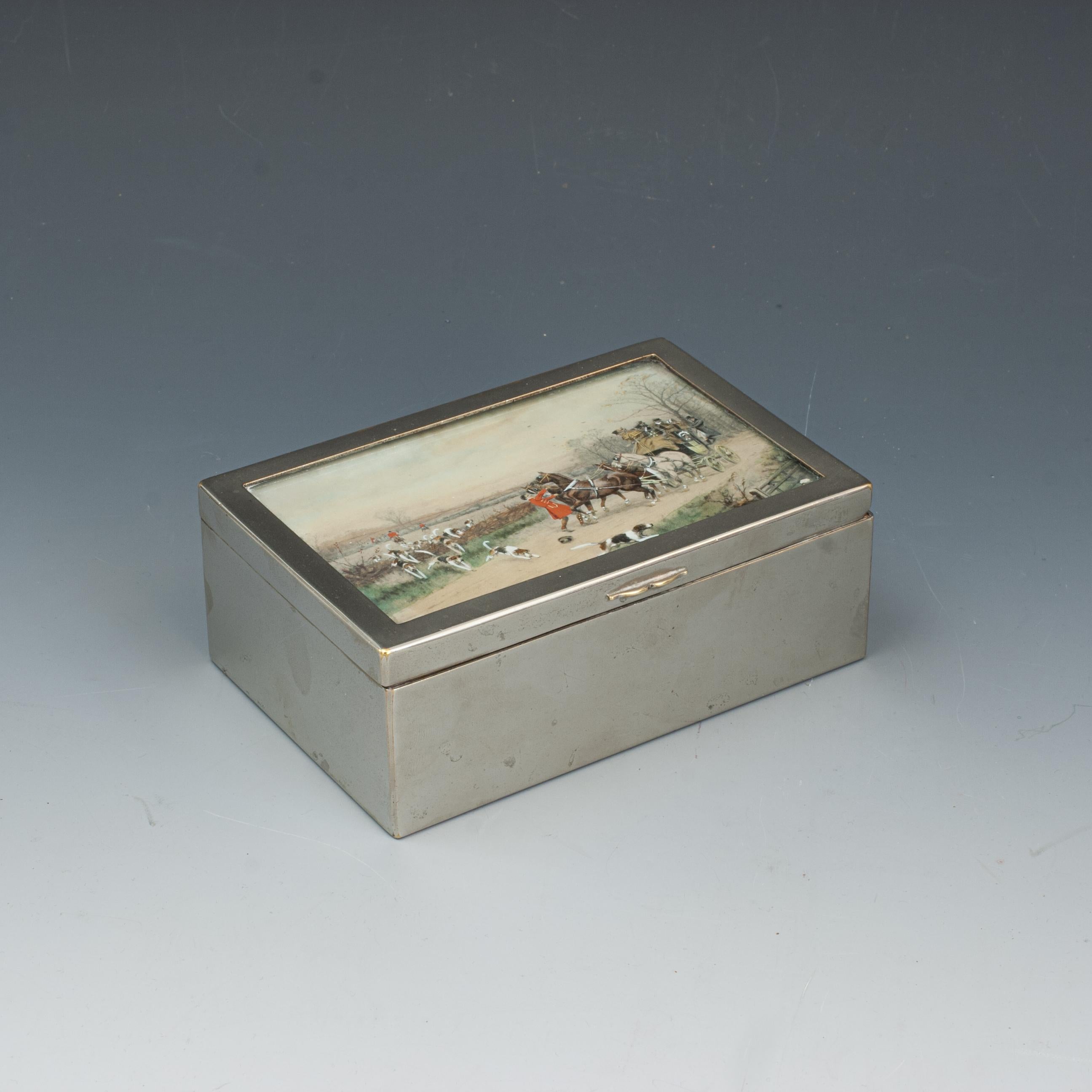 Antique Silver Plate Hunting Cigarette Case, Cigar Box.
A cigarette box with cedar wood lining and with silver plated frame. The lid containing a hand coloured hunting and coaching scene behind glass. Originally a smokers item but could easily be