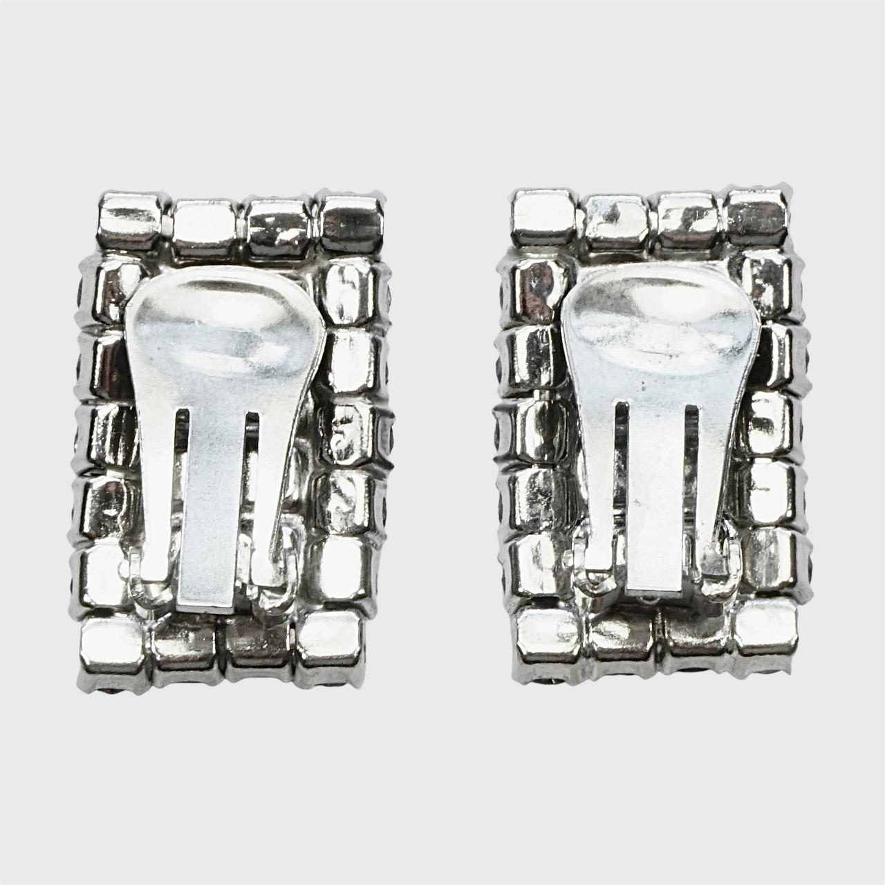 Bellissimi orecchini a clip rettangolari placcati in argento, impreziositi da strass sfaccettati a baguette e rotondi. Gli orecchini sono in ottime condizioni.

Misura 2,5 cm di lunghezza per 1,5 cm di larghezza.

Questi classici orecchini vintage
