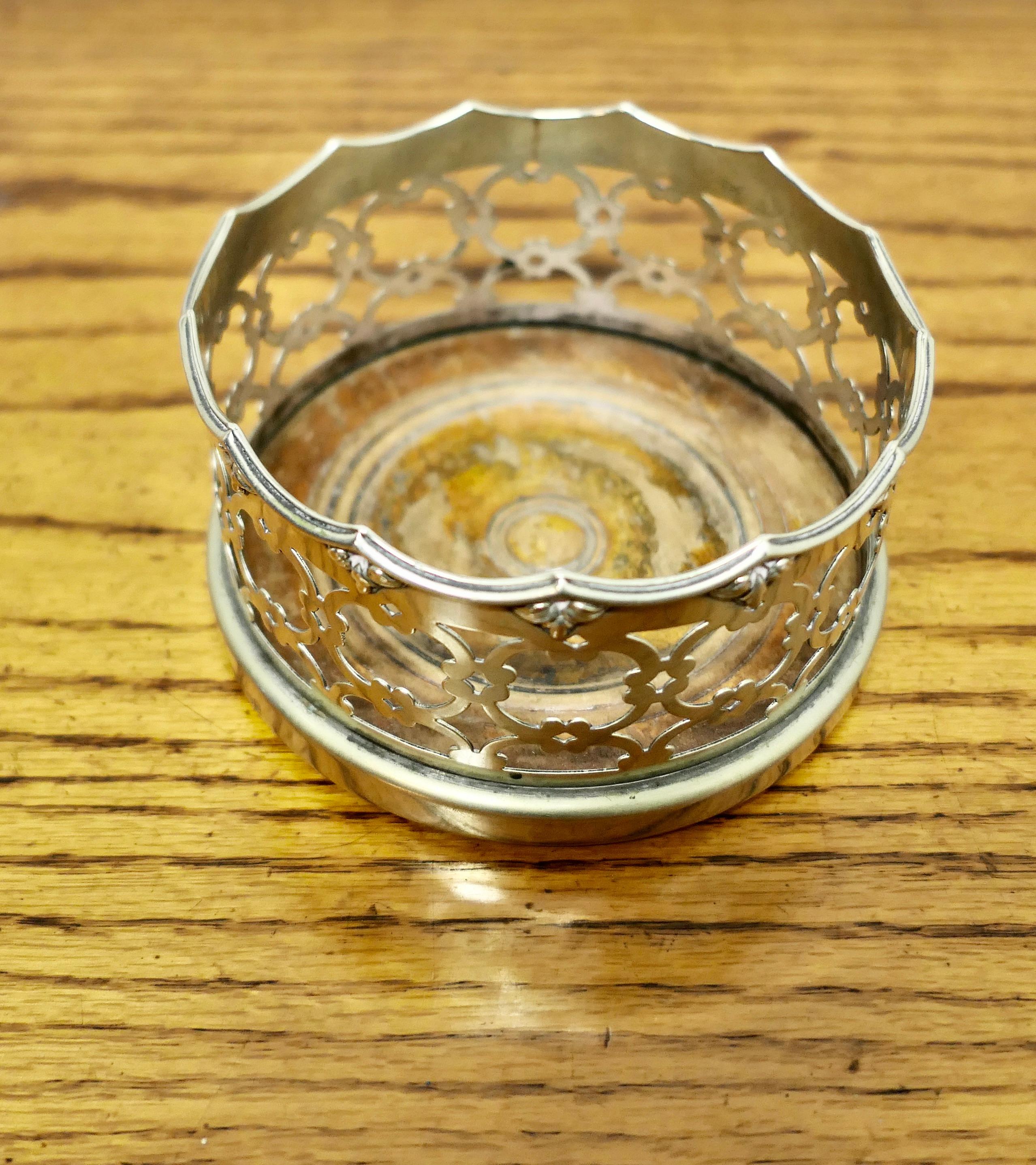 Silver Plated Coaster for a Magnum of Champagne 

A very attractive little piece, it has a turned wooden base and a 5” decorative filigree collar

In well used good condition, and a delightful piece for your serving table
The stand is 7” tall, and