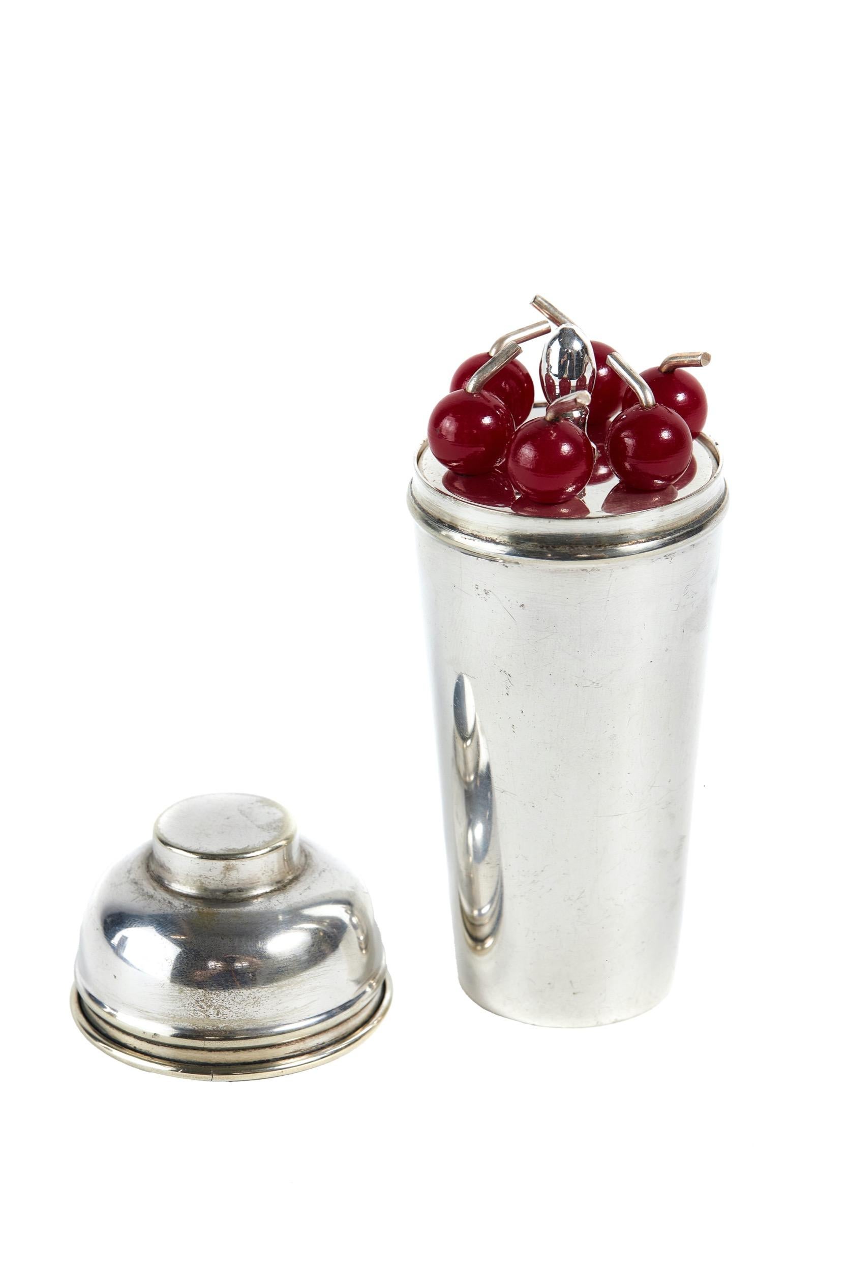 Silver Plated Cocktail stick holder in the form of a Cocktail Shaker
circa 1930s
inner silver plated stand lifts out
 holding 6 cocktail sticks with
Red Bakelite Cherry tops 
stamped on base P.H.V &CO 
E.P.N.S Made In England
good condition no dents