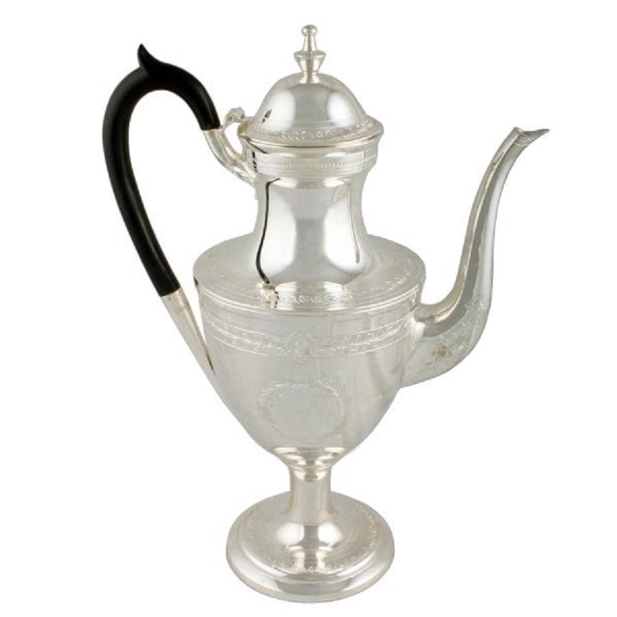 An 18th century Georgian style Victorian silver plated coffee pot.

This elegant coffee pot has a shaped ebonised wood handle, engraved decoration of leaves and flowers, a hinged lid with an urn finial and a slim spout.

The coffee pot has been