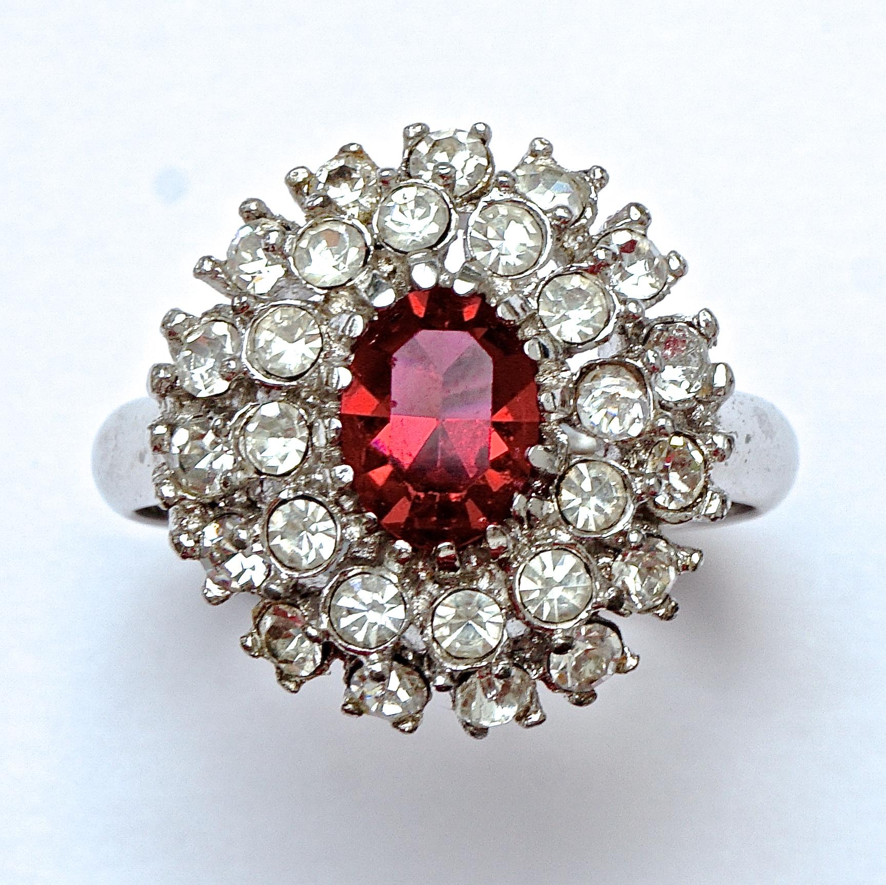 Beautiful silver plated adjustable ring featuring an oval dark pink centre rhinestone, surrounded by  two rows of clear rhinestones. Ring size UK Q / US 8, inside diameter 2cm / .78 inch. The front measures 1.9cm / .74 inch by 1.8cm /  .7 inch.