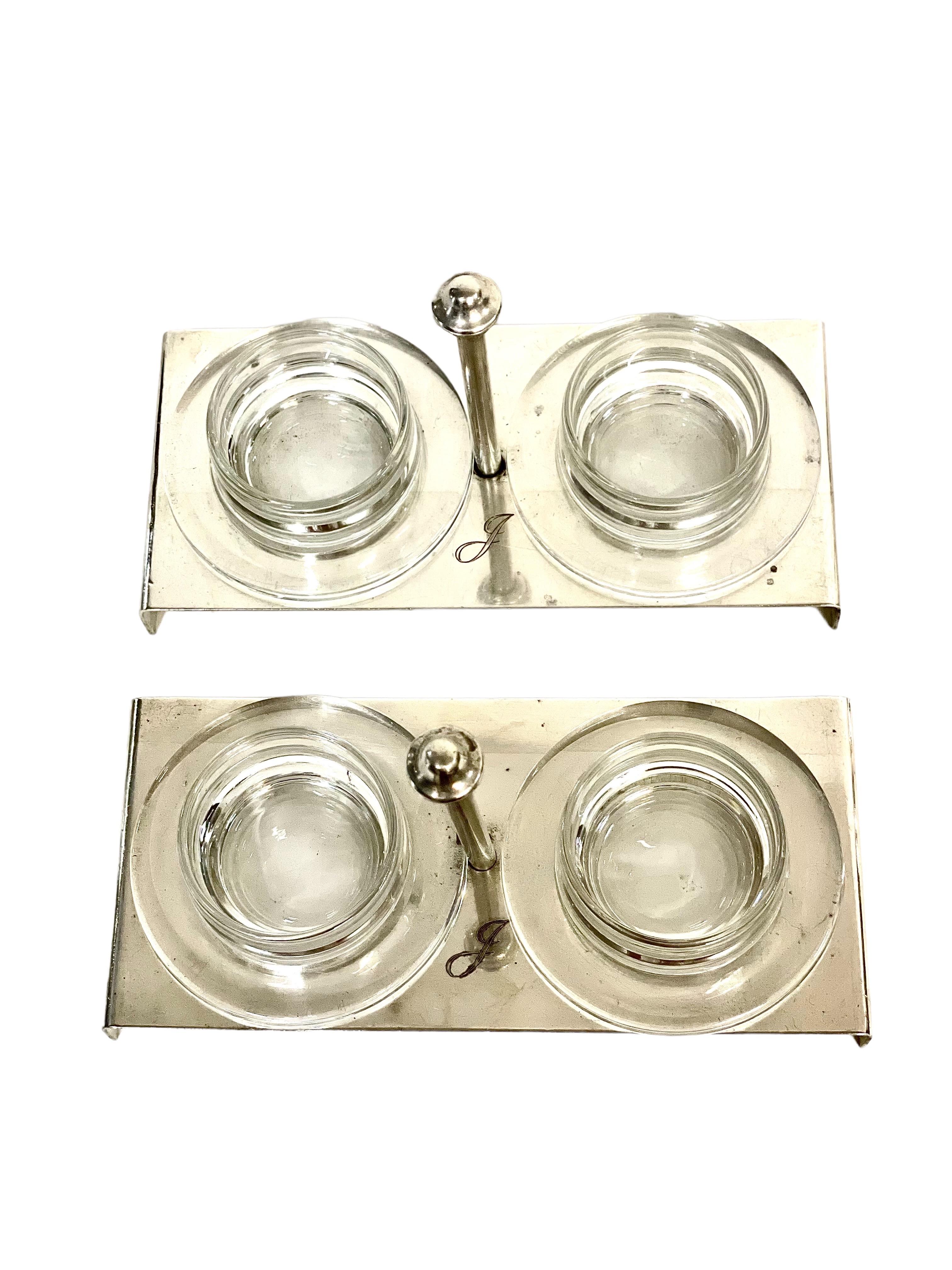 A rather stylish 1950s double butter dome, its silver-plated cloches mounted on a raised rectangular base, with central carrying handle. Each dome lifts off to reveal a (modern) glass dish, which makes the service extremely easy to clean. The set is
