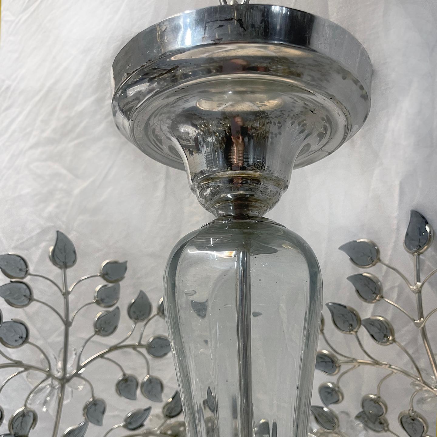 French circa 1950's silver-plated light fixture with smoke colored glass leaves, crystal flowers and eight interior lights.

Measurements:
Diameter: 30