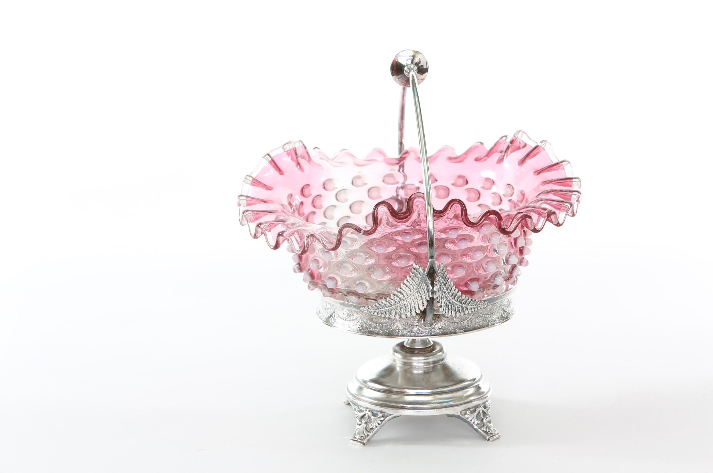 Silver plated framed holding base with foliate floral design details / pink crystal top brides basket. The brides basket is in great condition. Maker's mark undersigned. The piece stands about 11