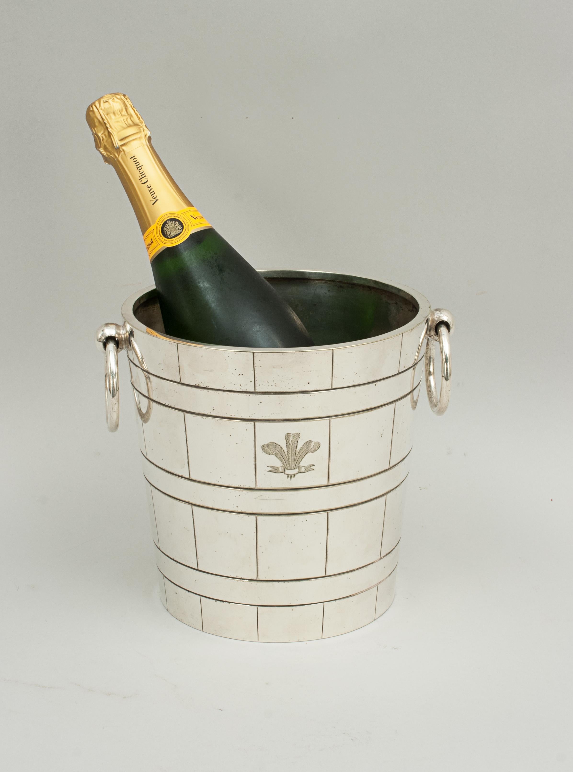 Vintage henry turner champagne ice bucket.
A heavy duty, high quality champagne ice bucket. The metal bucket is plated and polished with a pair of drop ring handles with an internal drainer. The front engraved with Prince of Wales plume of three