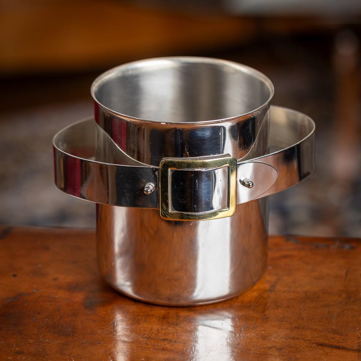 A superb mid-20th Century silver plated ice bucket. The bucket is adorned with a brass belt buckle detail and offers ample space to accommodate a bottle of champagne. It serves as an ideal enhancement for any home, whether contemporary or