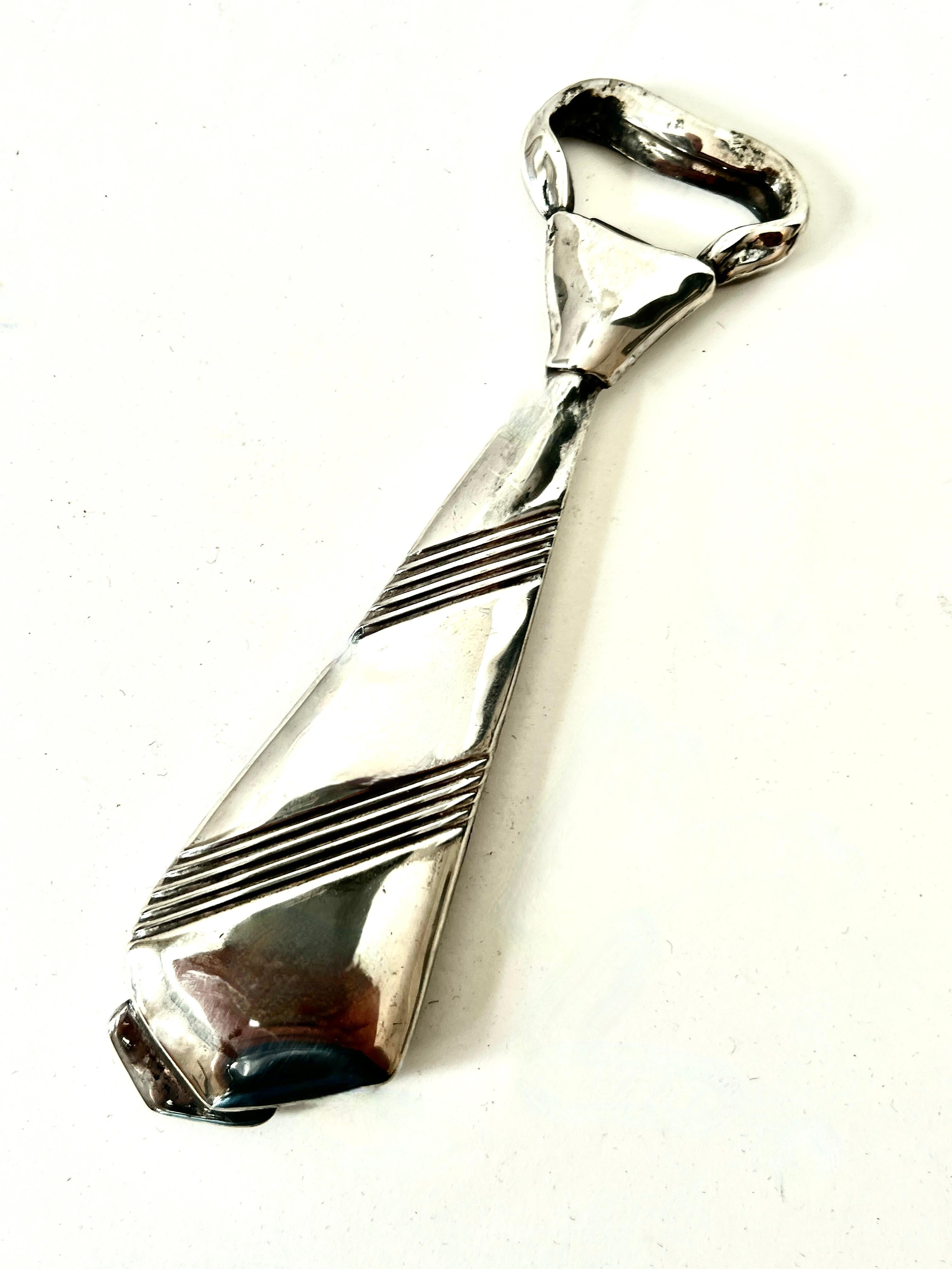 A clever designed Silver plated bottle opener.  The Opener is in the shape of a bow tie.  A novel bar accessory, perhaps for the workaholic that needs something neat at the end of the day.

The tie is Italian so it has to be fashionable...

The
