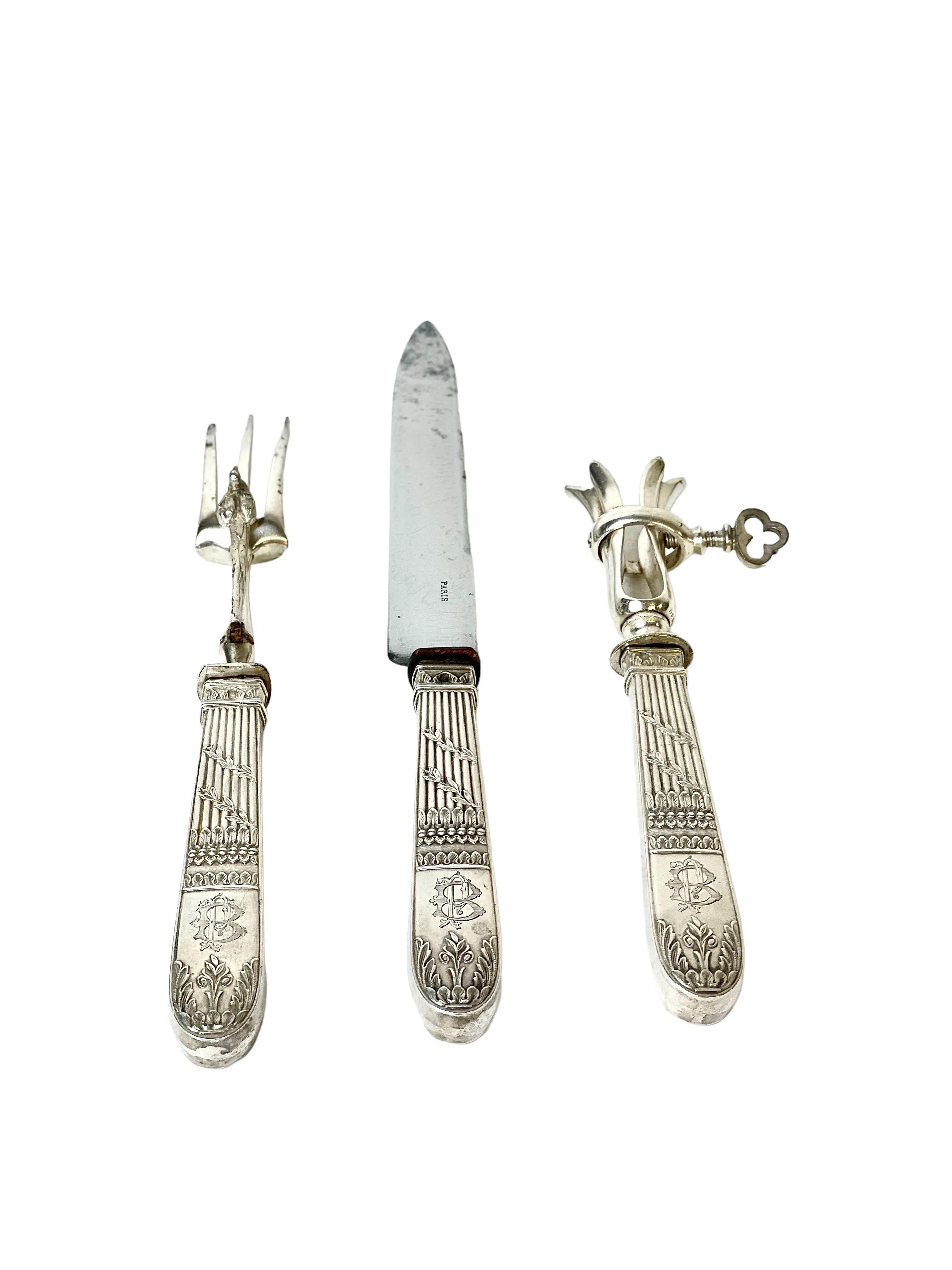 A very charming vintage French lamb carving set with silver-plated handles, comprising a carving knife, carving fork and leg-bone holder. Each implement features a beautifully fluted handle, entwined with a spray of olive leaves, and emblazoned with