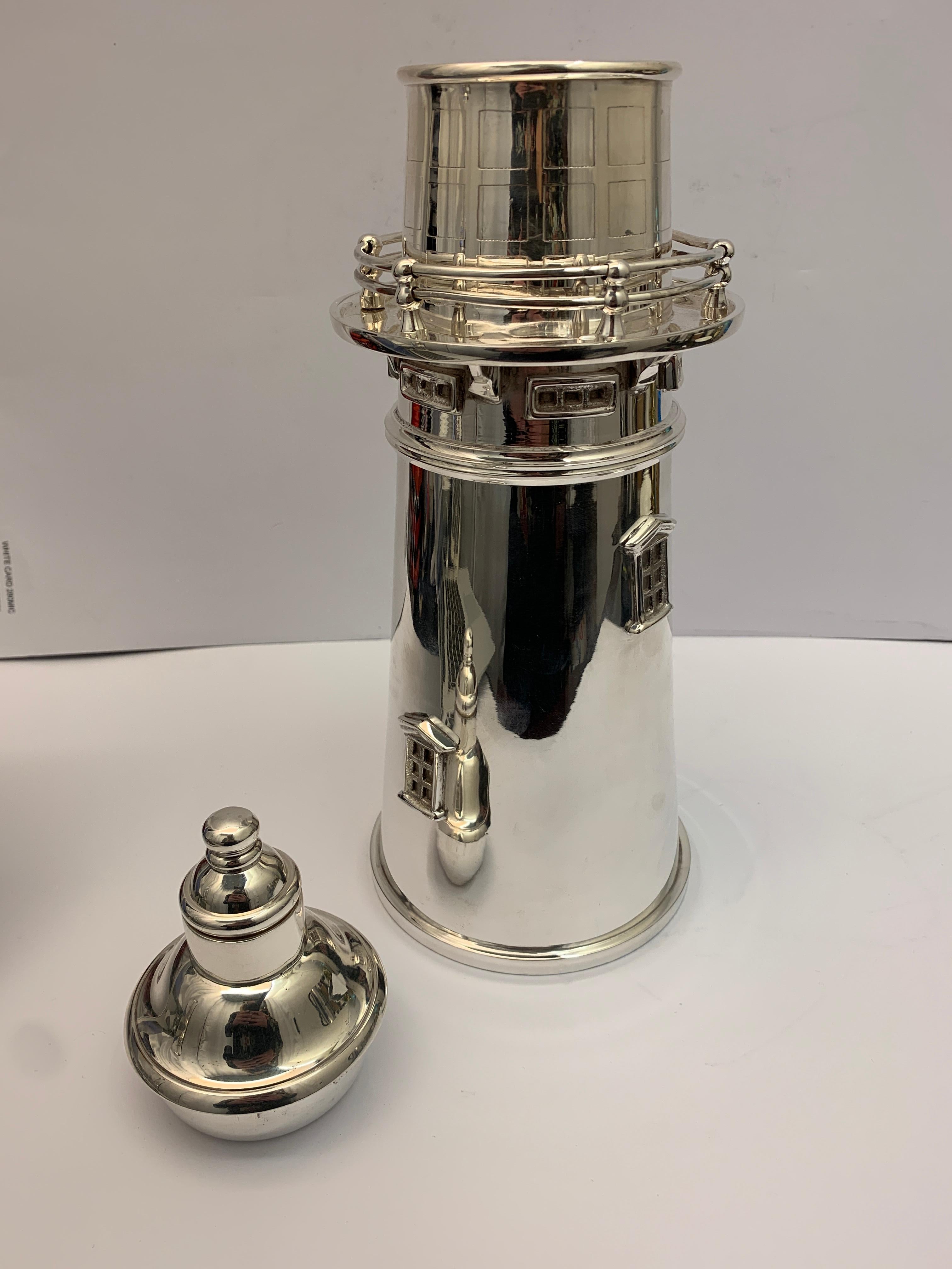 A large modern lighthouse shaped silver plated cocktail Shaker. With detachable top and pourer.