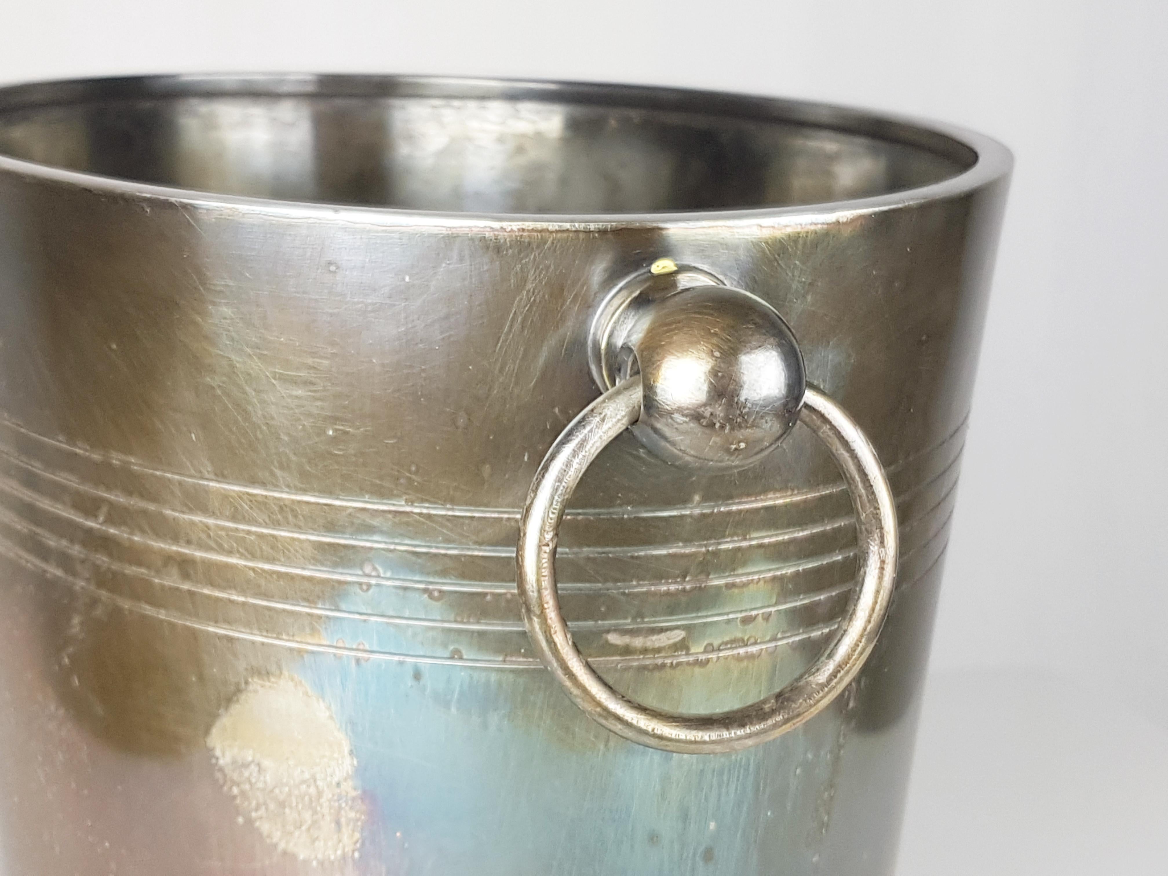 Silver plated metal ice bucket by Christofle. Manufacture mark on the base. Very good condition: The oxidation patina can be polished upon request.