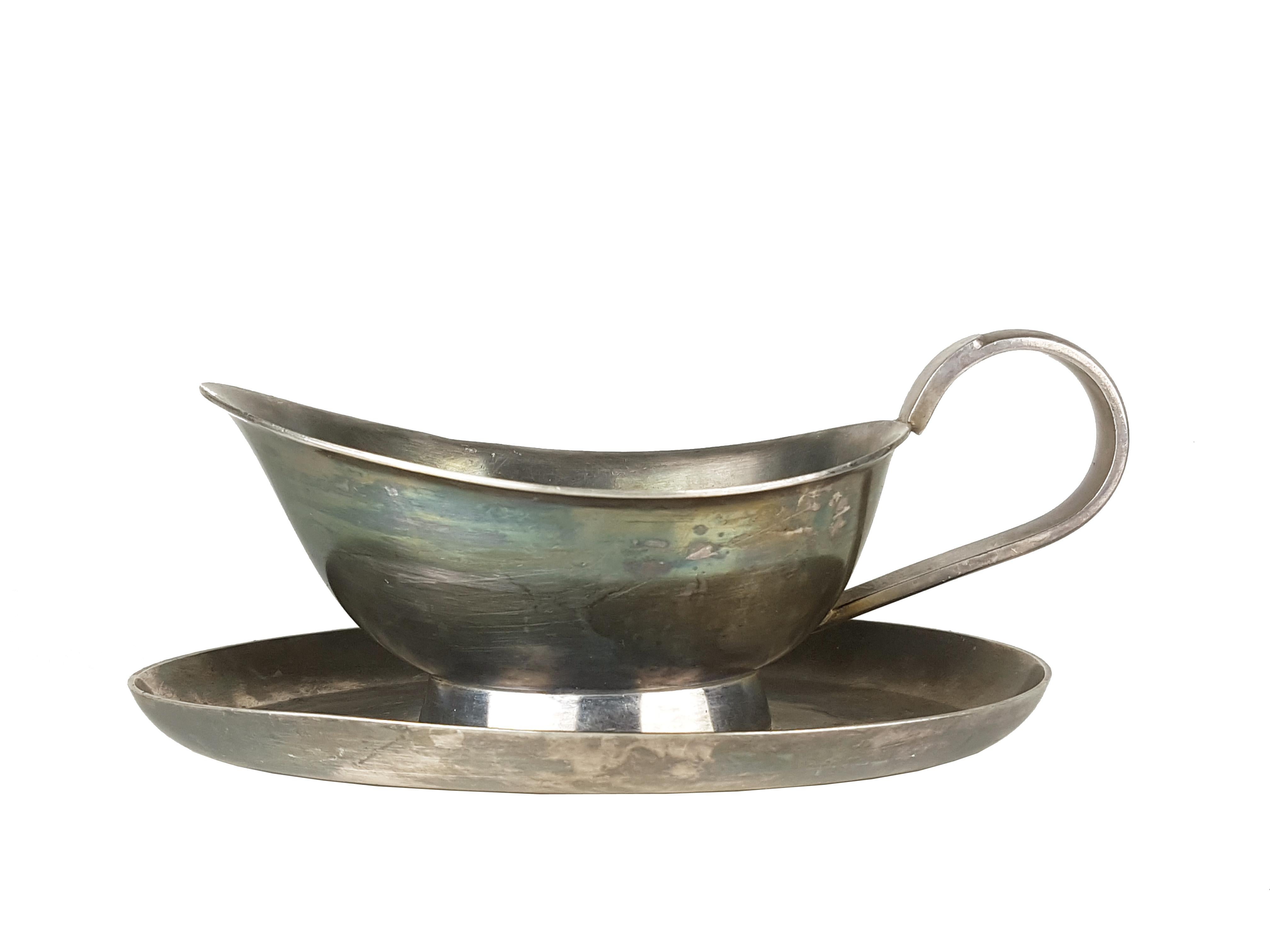 These rare Alpacca items were designed by Gio Ponti for Calderoni Argentieria in the 1930s. They remain in very good vintage condition: normal oxidation of silver metal which can be polished.
Dimensions:
Gravy boat: cm 7,5 h x 22 w x 14 d
Milk jug: