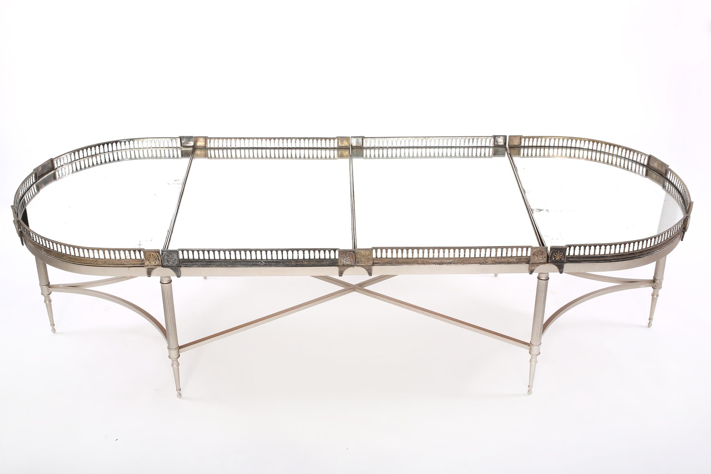 Early 20th century silver plate framed four mirrored piece sur tout de table gallery top cocktail / coffee table with exterior design detail. The cocktail table is in good condition with age / use appropriate wear. The cocktail table stand about 67