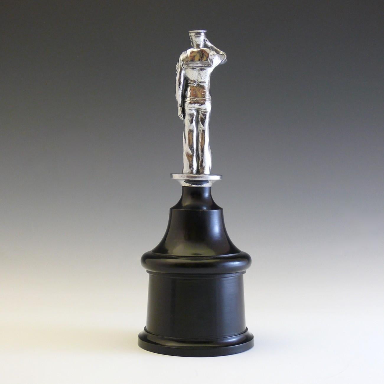 A stylish Naval car mascot mounted on an ebonised plinth for display; stamped with the name ‘Gieves’ as it was originally retailed by the renowned Savile Row tailors (and naval uniform suppliers) Gieves & Hawkes.

Dimensions: 30 cm/11¾ inches