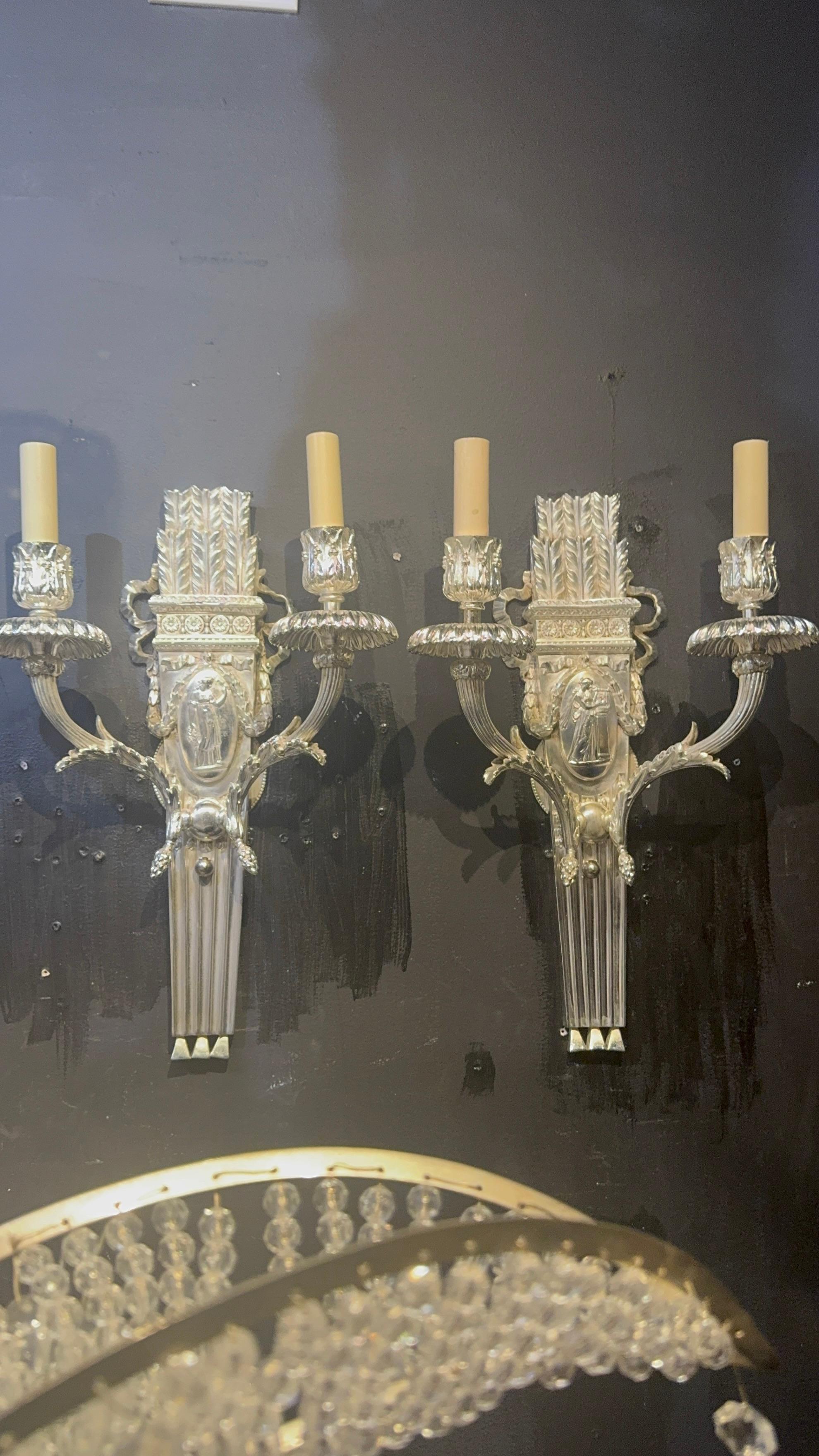 A pair of 1900 silver plated Caldwell sconces with Neoclassic design