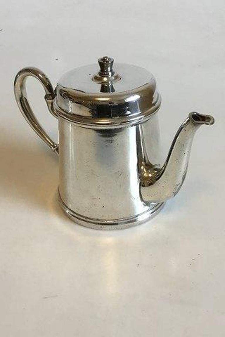 Silver plated pitcher with lid and logo from DSB (Dansih Rail Road). 

Measures 15.5 cm / 6 7/64 in.
 