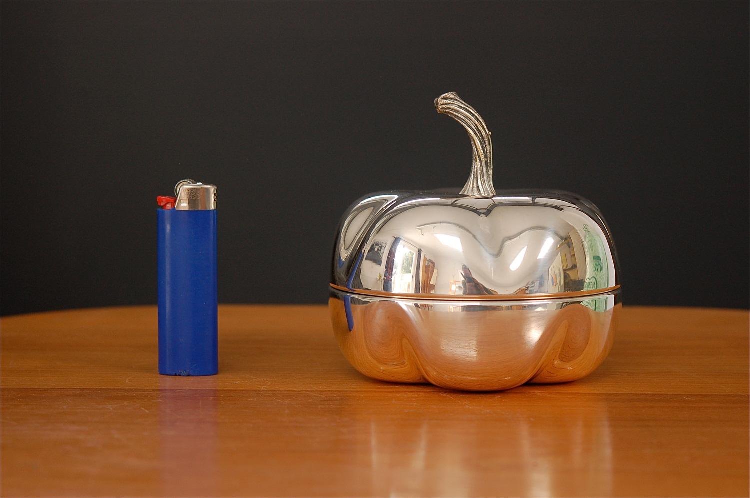 Silver plated decorative box in the shape of a pumpkin. This lidded box has an etched logo underneath and is marked silver plated. Fine detailing in the stem. Made in the style of Christian Dior. Perfect Halloween gift. Measurements: 4.75 in