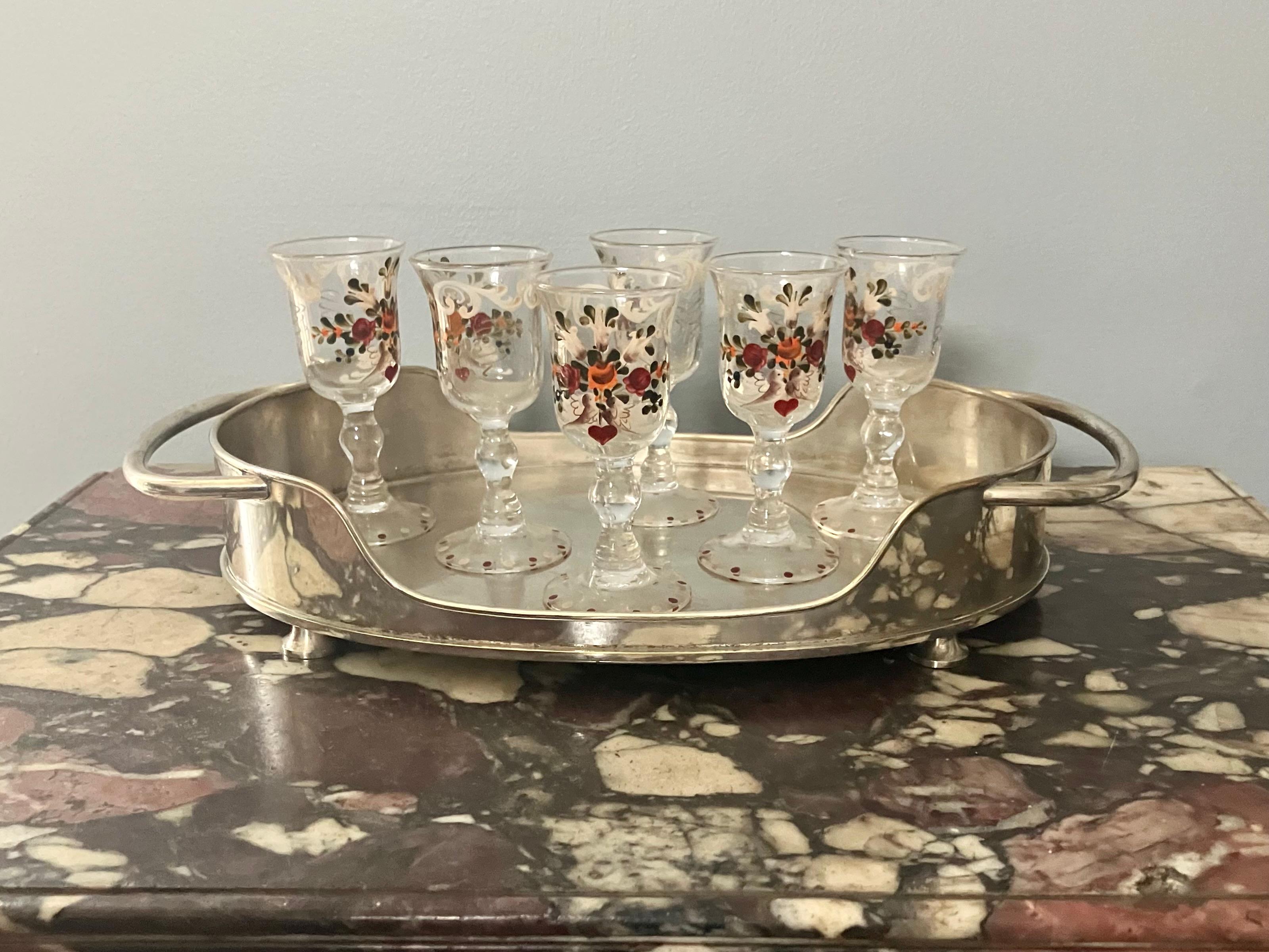 Silver plated serving tray. Vintage English silver plated brass handled and footed drinks serving tray. Unusual Forties style oval tray with scooped gallery on inverted cup feet.  
Dimensions: 14.25 W handle to handle x 8.38