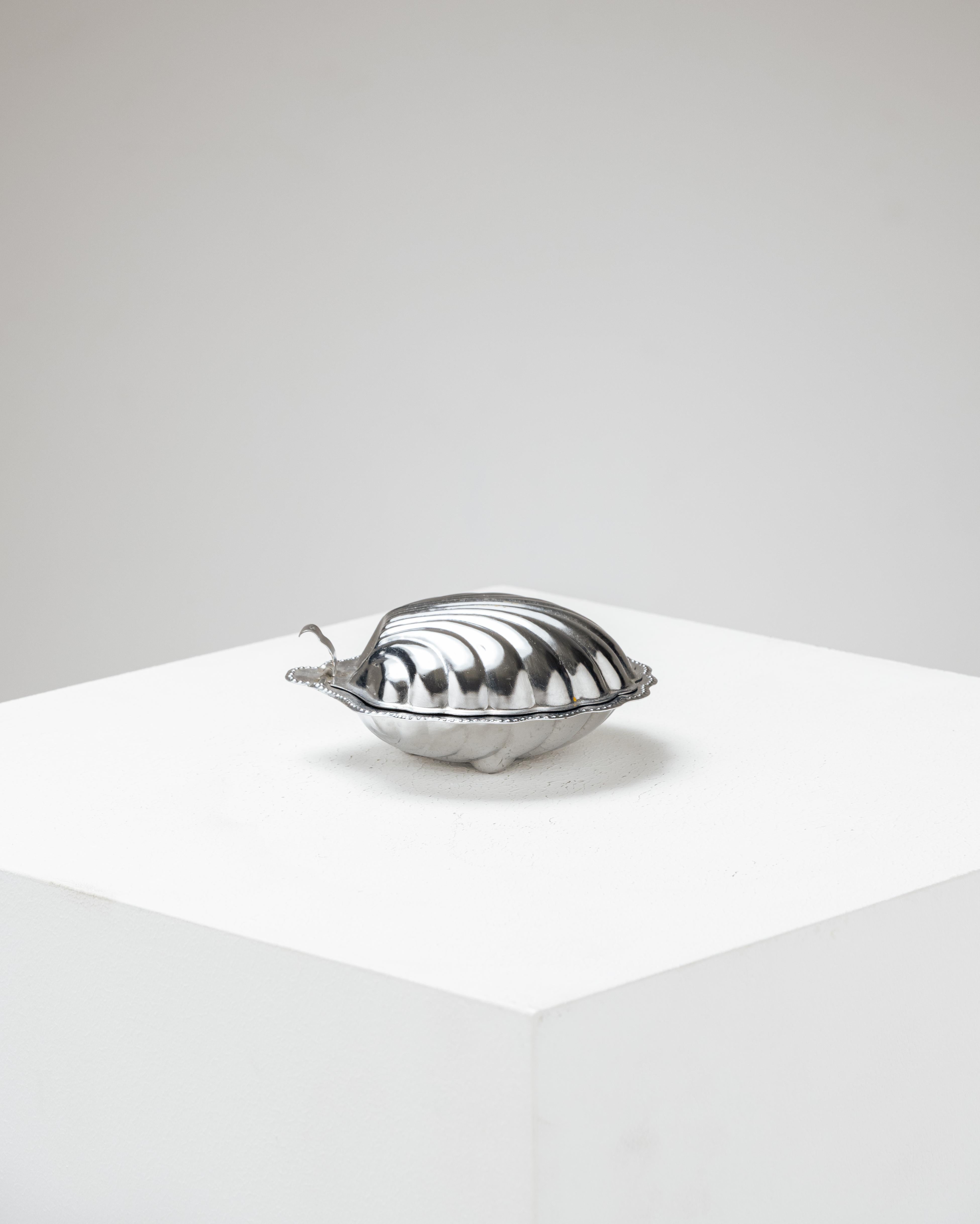 Silver-plated shell butter dish from the 70s.
Composed of a silver-plated metal dish and a matching lid. It features a removable frosted glass insert. Slight patina on the metal, overall good condition.

LP5449
