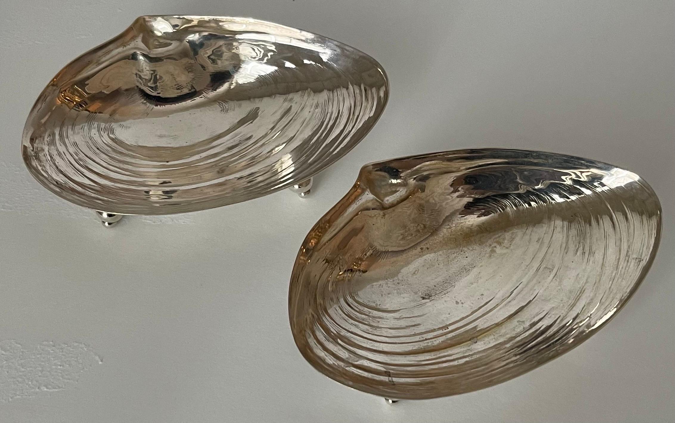 Pair of silver plated shell candy dishes or ashtrays. No makers mark or brand stamp.