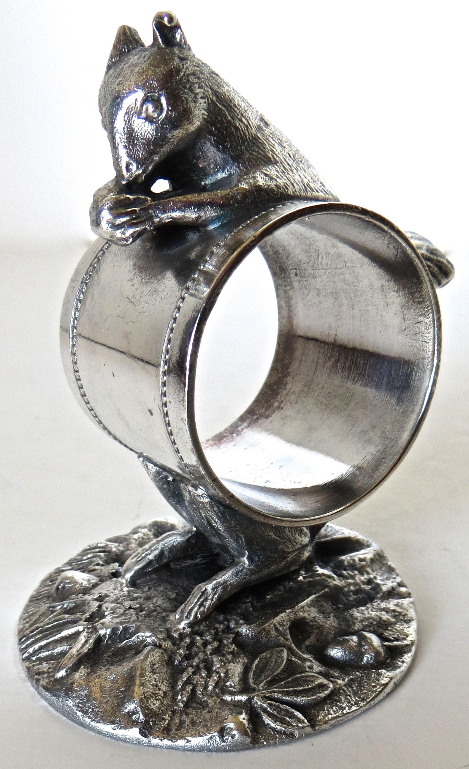This is a much sought after Victorian silver plated figural napkin ring which depicts a squirrel eating a nut atop the ring. It is very nicely cast, depicting in great detail, the features of the squirrel and the foliage at the circular base which