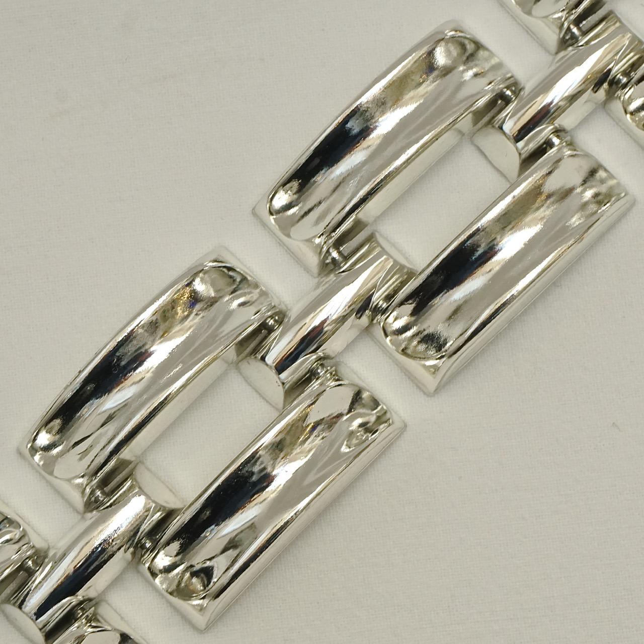Great silver plated wide tank style link bracelet.  Length 17.3cm / 6.8 inches by width 3.2cm / 1.26 inches. There is some wear to the silver plating.

This is a wonderful silver tone statement bracelet in a simple classic design. Circa 1980s.