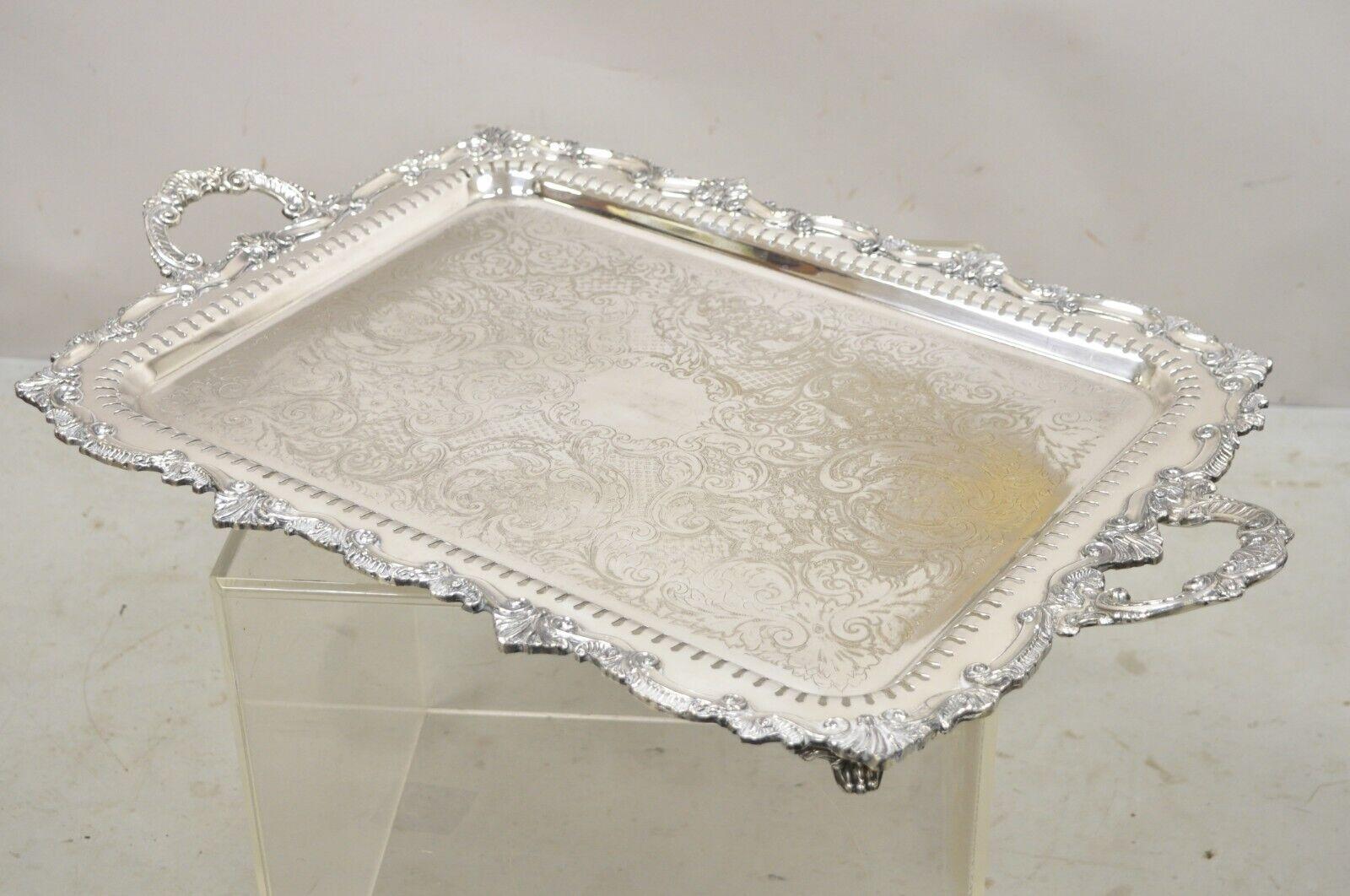 Vintage silver plated Victorian style twin handle serving platter tray with Pierced Gallery. Item features pierced gallery, ornate twin handles, raised on feet, very nice vintage item, great style and form, circa early to Mid-20th Century.