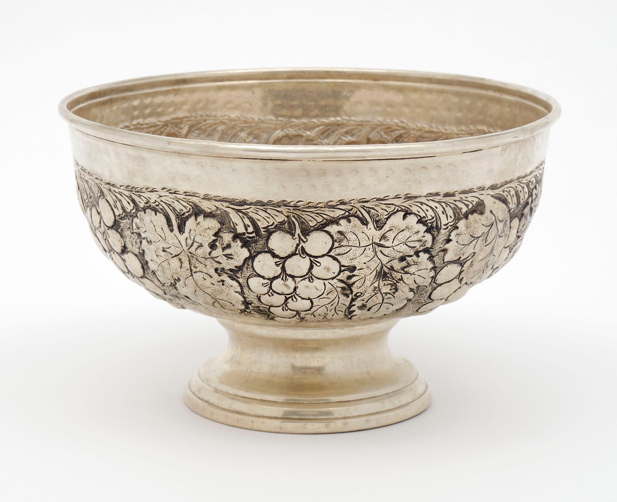 Large wine bucket from France made of embossed silver-plated brass with a rich decor of grapes and grape wine leaves.