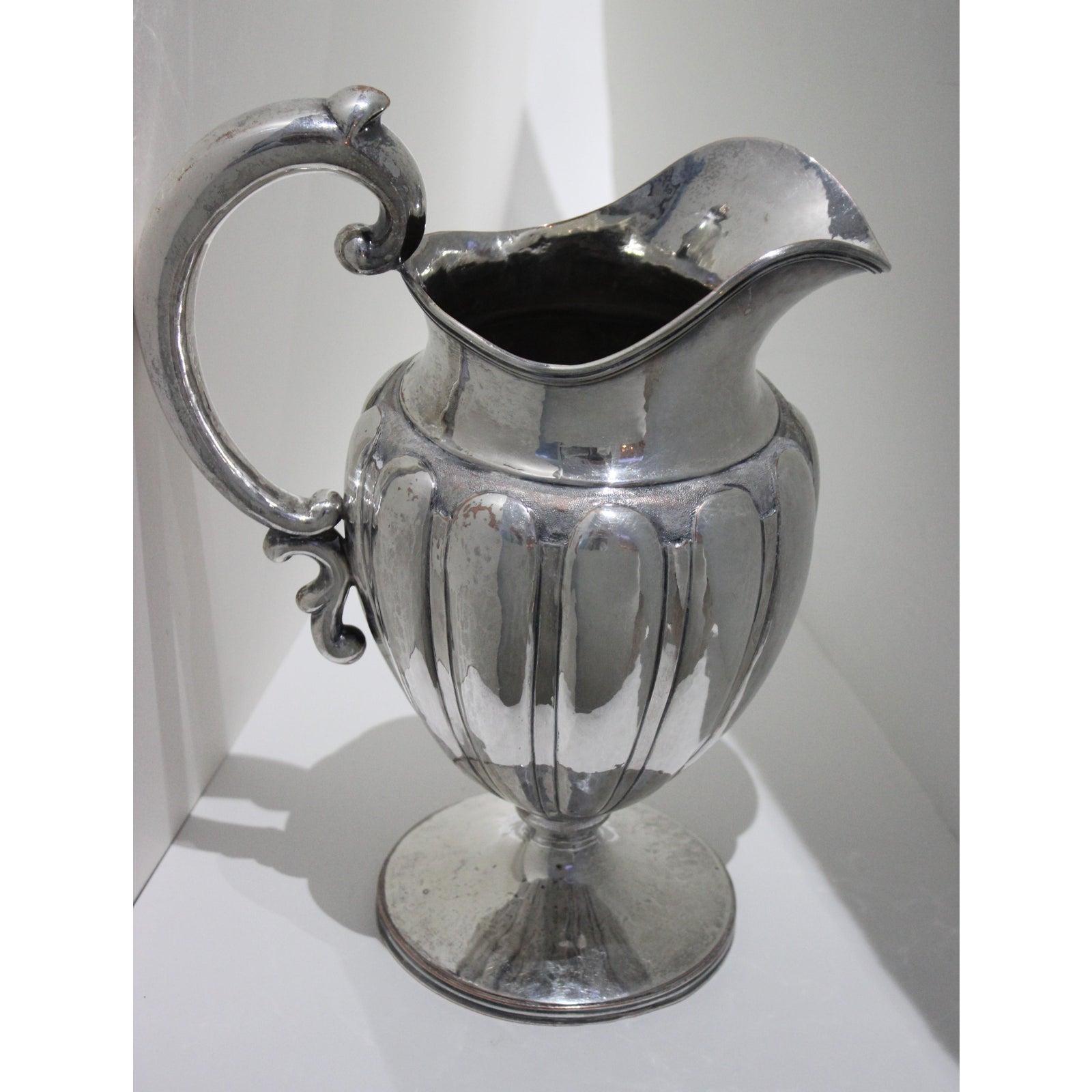 This stylish and Classic melon-form silver plated over copper water pitcher will make a great addition to your barware collection and of course a special place on your holiday table settings.

Note: There is some loss of silver-plate over the