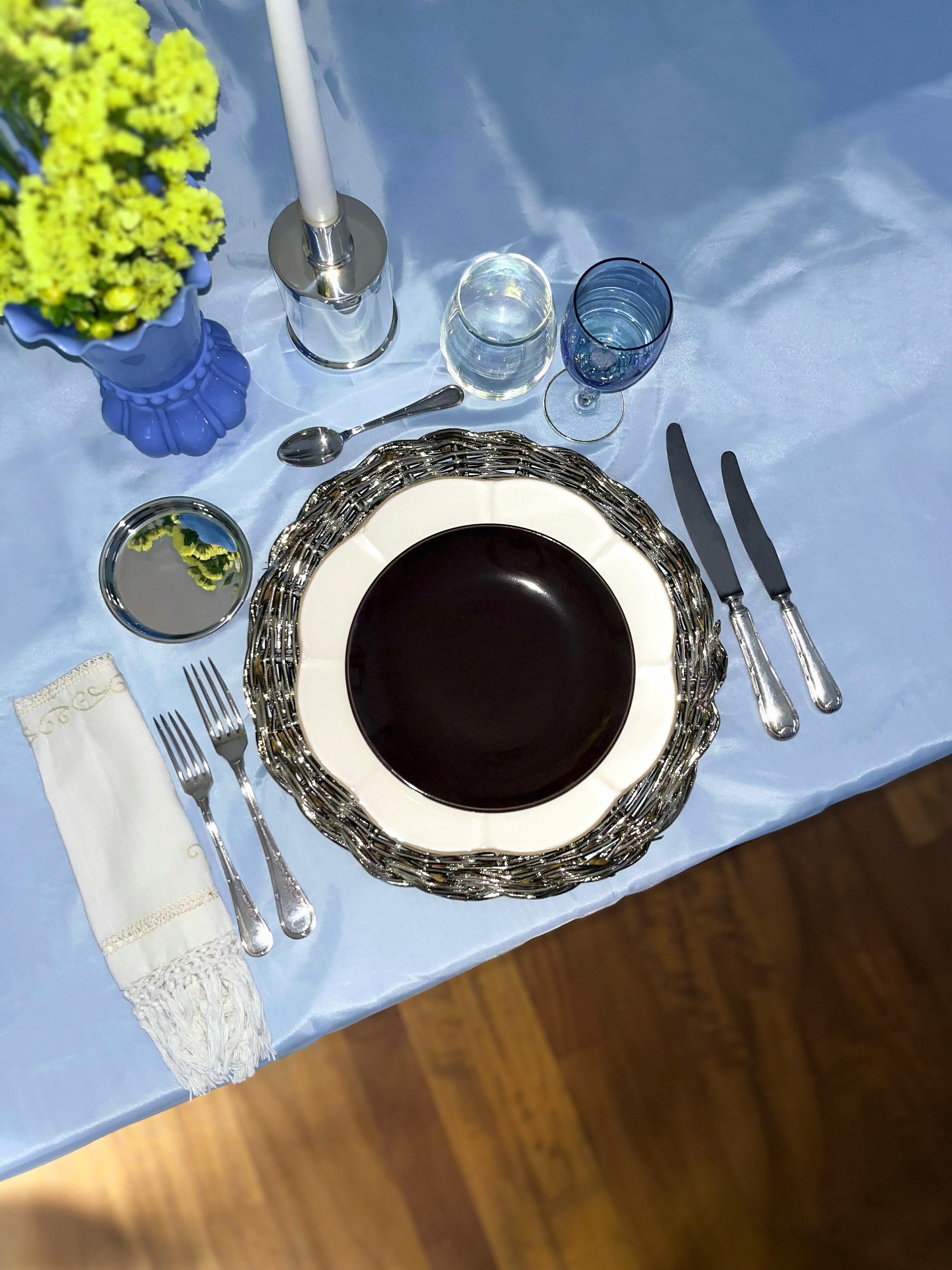 This versatile silver-plated placemat can serve as a sophisticated table accessory, a decorative charger under plates, or a stylish base for candles, floral centerpieces, and sculptural compositions. Its refined circular form and handwoven quality