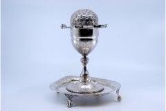 Silver poppy-shaped toothpick holder on claw-foot base