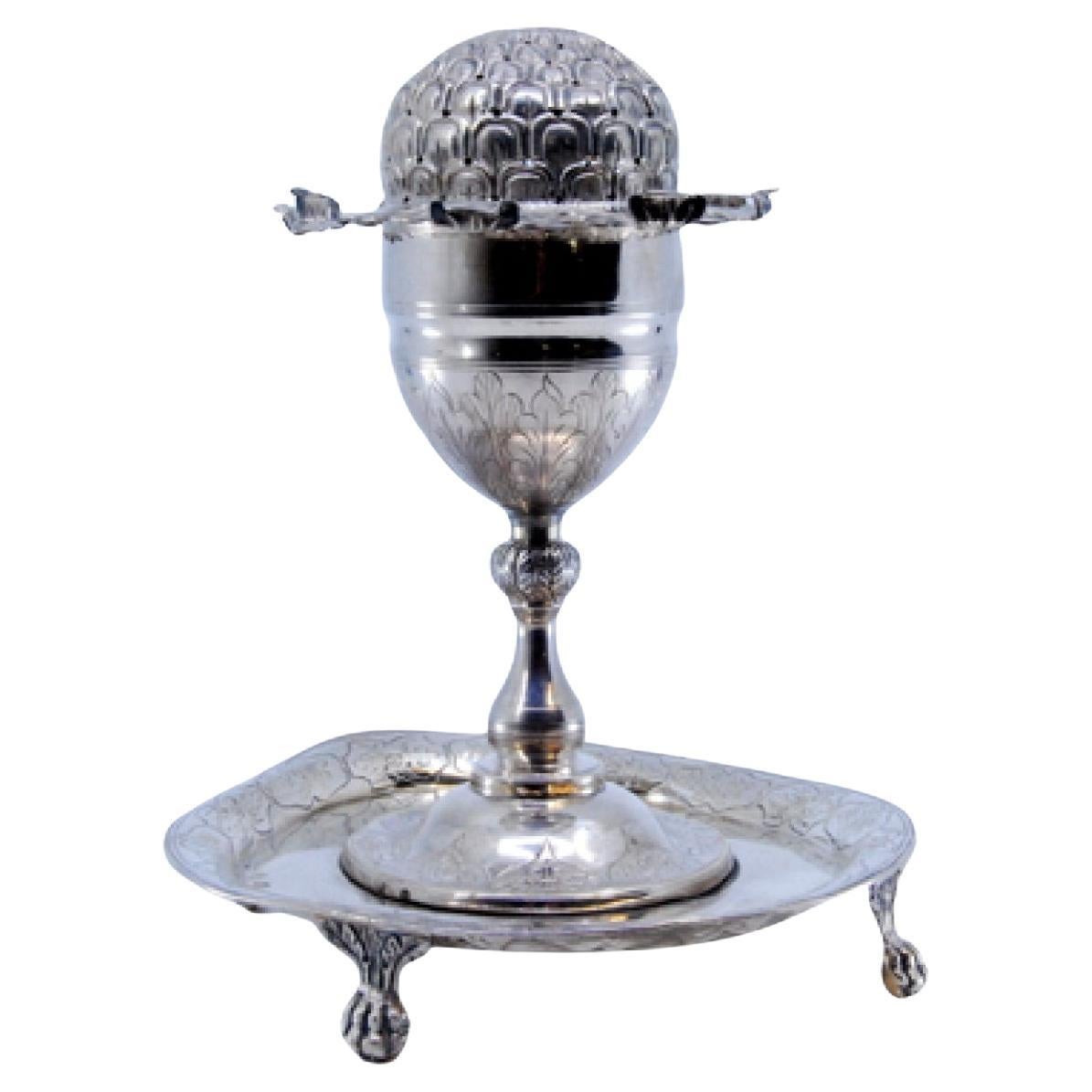 Silver poppy-shaped toothpick holder on claw-foot base