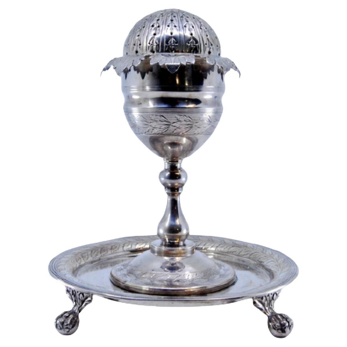 Silver poppy-shaped toothpick holder with palm-engraved base