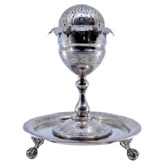 Silver poppy-shaped toothpick holder with palm-engraved base