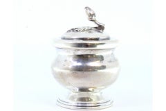 Silver pot with a base trim and a flower-shaped knob on the lid