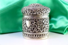 Silver pot with floral reliefs and monogram plaque on the removable lid