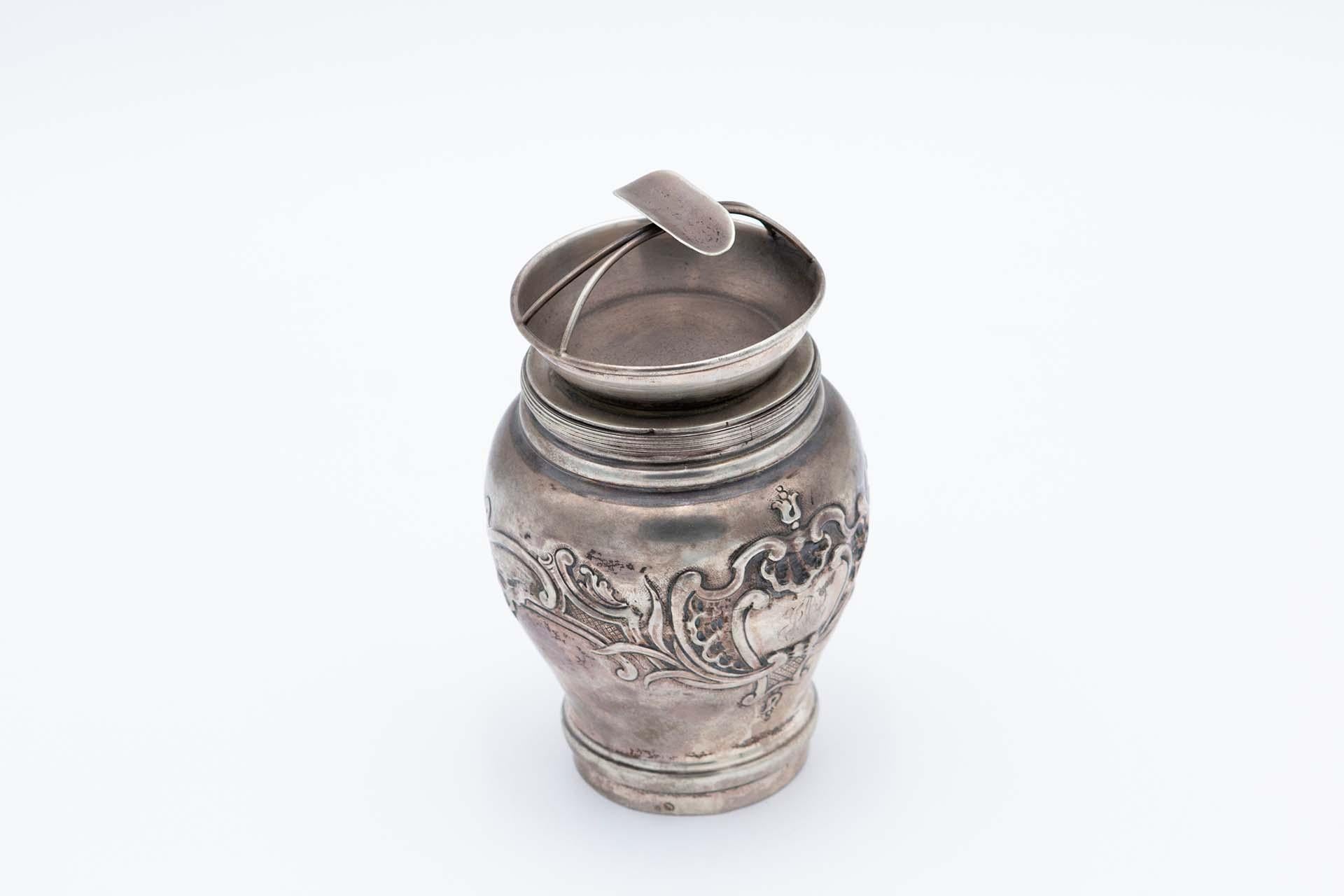 Silver pot with reliefs and filled bottom