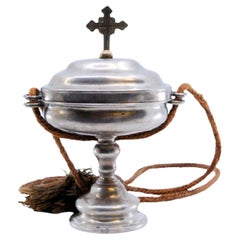 Silver pyx with cross on the lid and suspension cord Silver pyx with cross on the lid and suspension cord