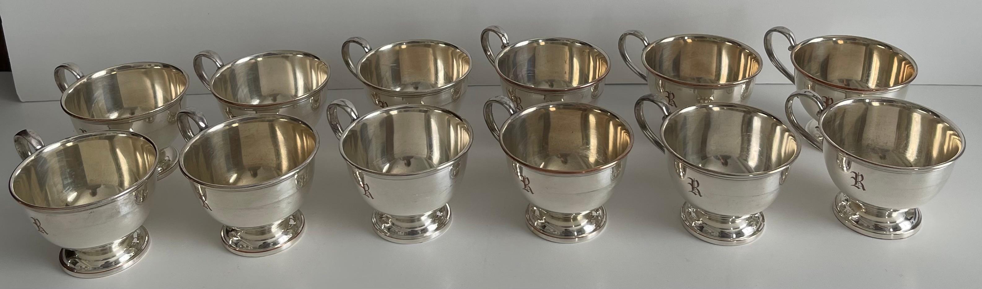 Set of 12 1950s silver plated punch cups. 
Single R monogram on each cup,
Stamped EPC (electroplated copper) on the underside. 

Cups have been newly professionally polished to a high shine but have overall areas of silver loss.