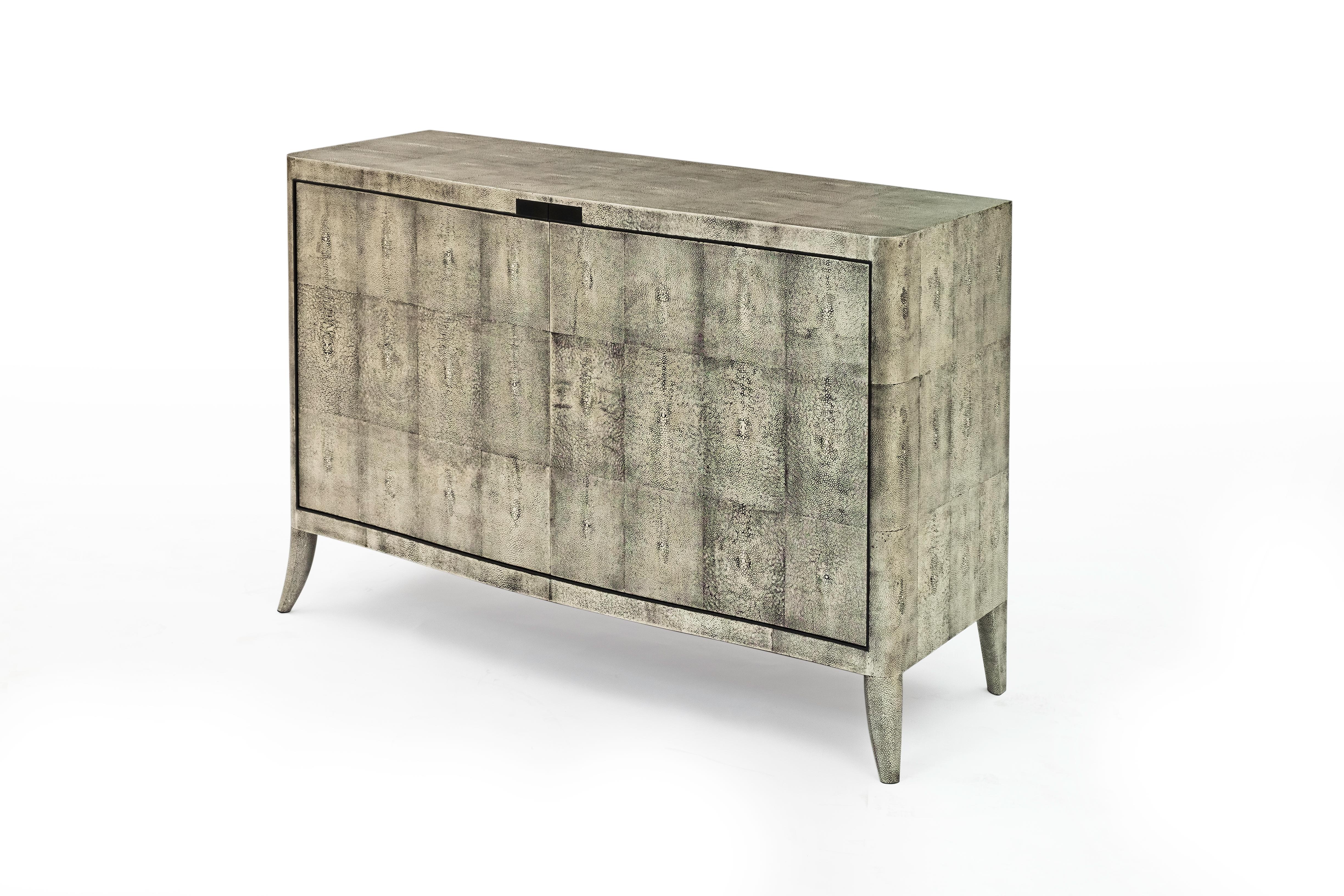 Designed by Jean-Paul Viollet.
Silver Ray Cabinet in white gold leaf on shagreen, grey dyed parchment interior, and Gabon ebony. 