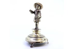 Silver reaper toothpick holder on smooth pedestal with three feet