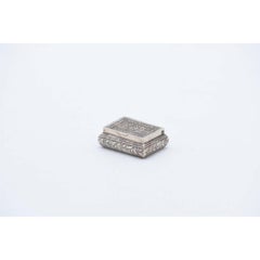 Silver rectangular pill box with flower reliefs