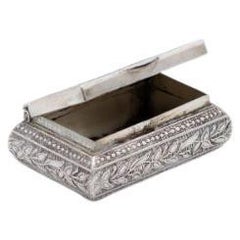 Silver rectangular pill box with flower reliefs