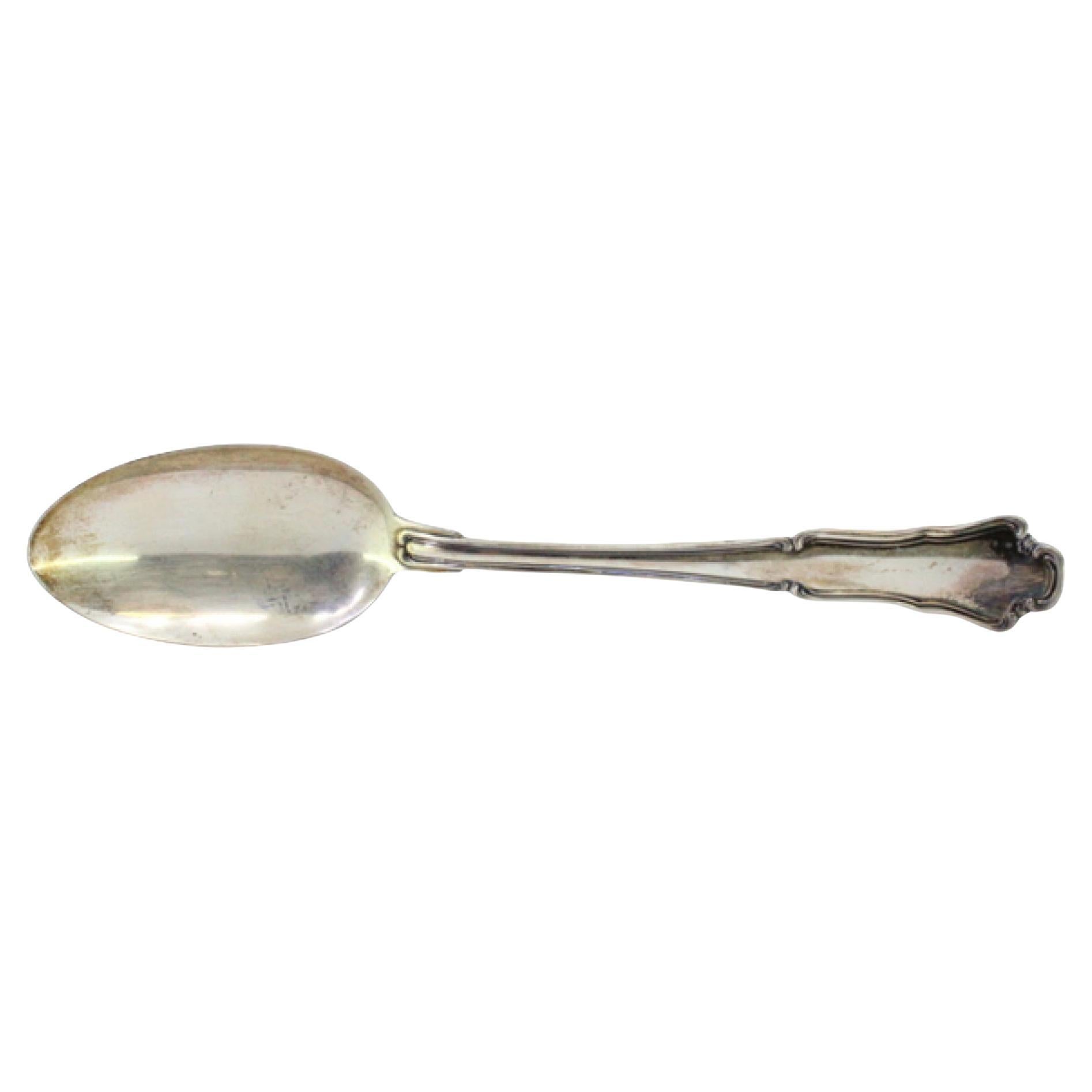 Silver rice and serving spoon with a long, scalloped handle